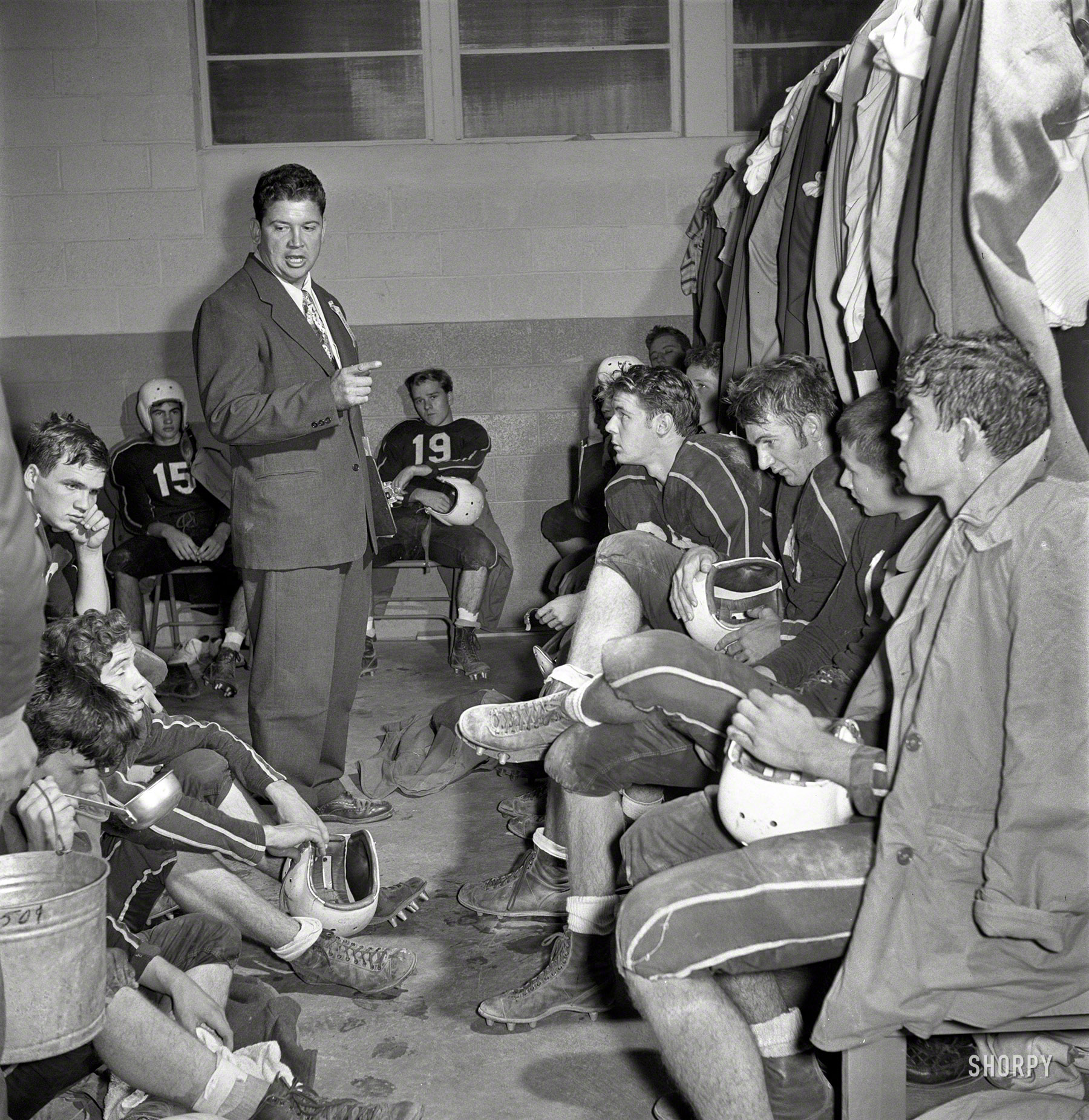 November 1952. A pep talk from Coach. "Hamlet (North Carolina) High School football team in locker room at away game." From photos by Douglas Jones for the Look magazine assignment "Football Weekend." View full size.