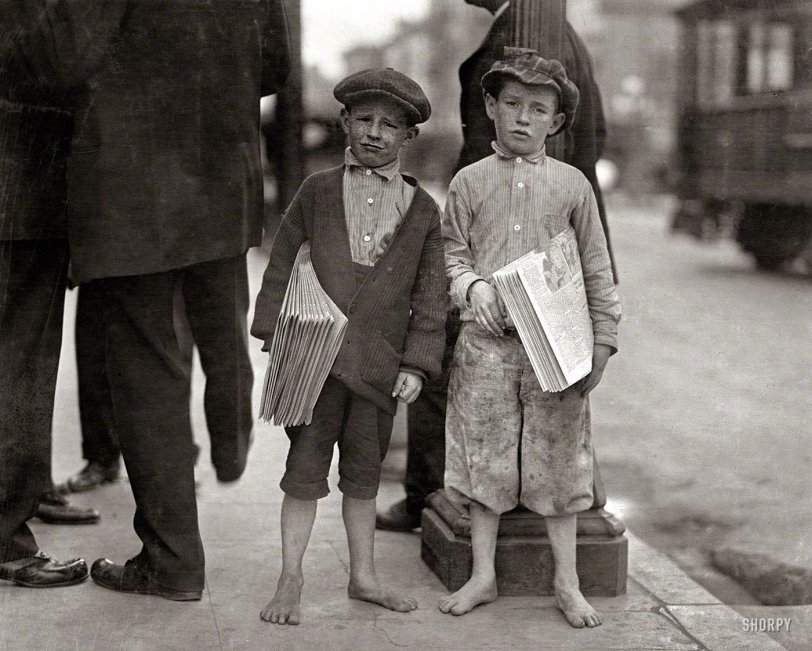 May 1915. "Nine-year-old newsie and his 7-year-old brother 'Red.' Tough specimen of Los Angeles newsboys." Photo by Lewis Wickes Hine. View full size.
