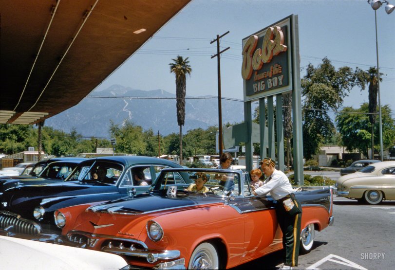 &nbsp; &nbsp; &nbsp; &nbsp; At Bob's ("Home of the Big Boy") in a 1956 Dodge Custom Royal convertible in the very mid-Fifties color scheme of coral and black.
June 1956. "Aspects of life in Southern California, including cars at drive-in restaurant, drive-in laundromat, drive-up bank, shopping center." (Next stop: the Pantorium.) Kodachrome by Maurice Terrell for the Look magazine assignment "Los Angeles: The Art of Living Bumper-to-Bumper." View full size.
