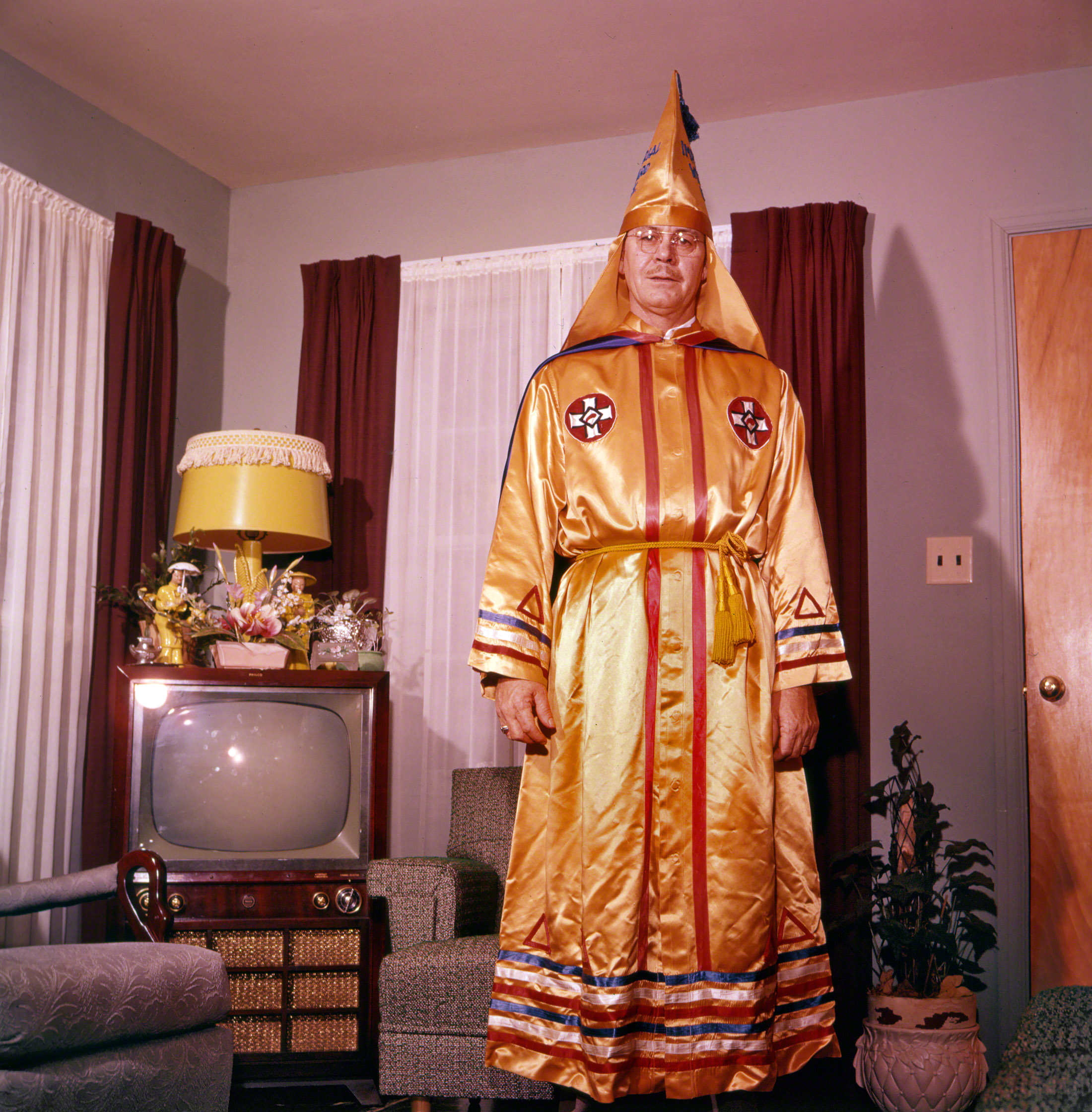 February 1957. "U.S. Klans Imperial Wizard Eldon Edwards posed in his official robes at home." Photo by Jay B. Leviton for Look magazine. View full size.