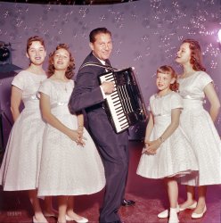 April 1957. "Entertainer Lawrence Welk playing accordion with the Lennon Sisters." (Or, as he would introduce them, "The lovely little Lennon Sisters.") Color transparency by Earl Theisen for the Look magazine assignment "Lawrence Welk: Nobody Likes Him Except the Public." View full size.