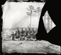 August 1864. "Petersburg, Virginia. Company C, 1st Massachusetts Cavalry." Wet plate glass negative, photographer unknown. View full size.