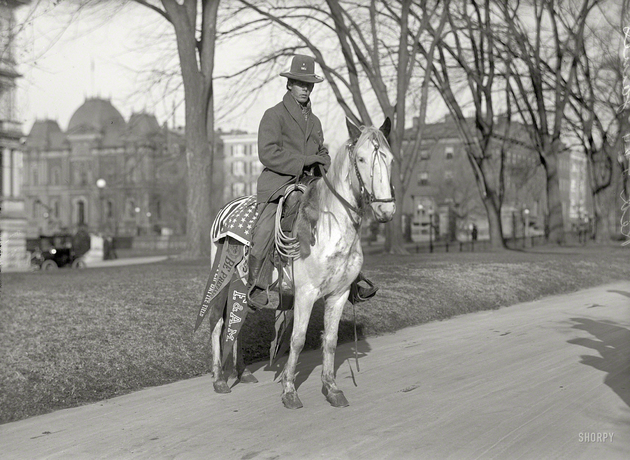 1915. "Indians, American. Red Fox James at White House." The young Blackfoot with the Boy Scouts pin, last seen here, was in Washington to petition the government for a national day honoring Native Americans. State, War & Navy Building at far left. Harris & Ewing Collection glass negative. View full size.