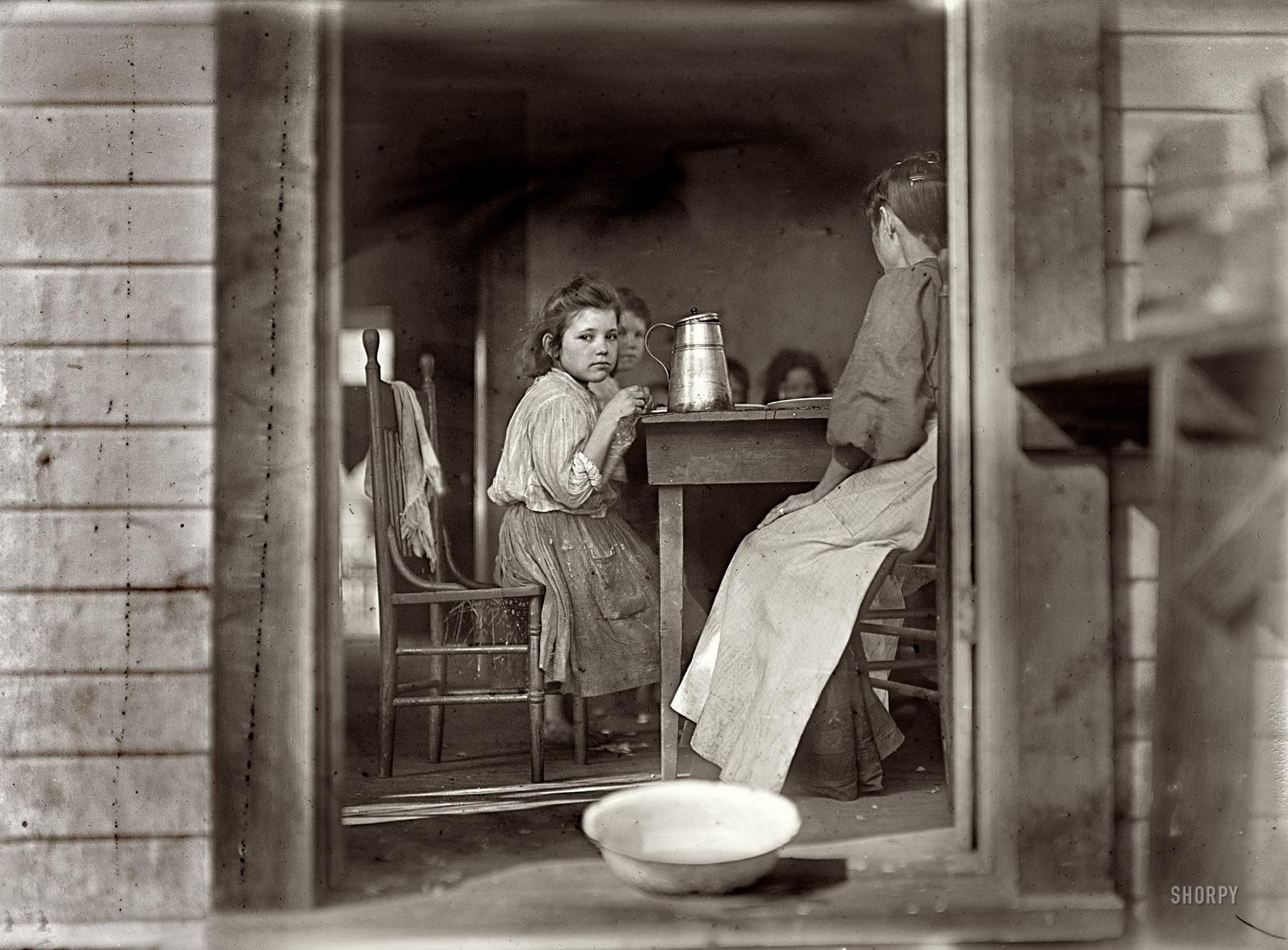 January 22, 1909. "Dinner time. Family of Mrs. A.J. Young, Tifton, Georgia." Last glimpsed here. Joe Manning of the Lewis Hine Project, who has spent five years unraveling the Young family's history, tells their story here in fascinating detail. Photograph by Lewis Wickes Hine. View full size.