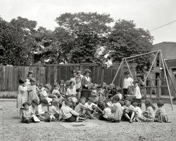 Washington, D.C., 1922. "Fair Bros. playground." The Little Rascals. National Photo Company Collection glass negative. View full size.
String and cardThat string and card thing has stirred up some ancient childhood memories, buried since... well, childhood. I remember using various colors of knitting yarn and winding up with a rudimentary needlepointy kind of thing. Sort of the equivalent of paint-by-numbers; presumably there was a name for it. So glad the exposure caught the kid on the swing; brings the scene even more to life. The ones looking back at the camera help, too, as well as the look of genuine delight on the face of the teacher (keeper?).
Unhappy GirlJust to the right of Pigtail Girl.
She looks like she just sat down on someones Peanut Butter Sandwich but she can't move until the picture is taken.
Der BingleSomehow I expect Bing Crosby to show up and sing, "Would You Like to Swing on a Star?"
Yarn cardsTterrace, we called them "lacing cards" back in the late 50s.
[That kind of rings a bell, thanks. - tterrace]
This is the beginners classAs is clearly indicated by the use of lacing cards. The advanced class on the other side of the playground gets pot holder looms.
(The Gallery, Kids, Natl Photo)