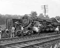 July 31, 1922. Laurel, Maryland. "Two B&amp;O freights wrecked in head-on crash at Laurel switch." Details here. National Photo glass negative. View full size.
Jumping and its perils and rewardsMy Uncle Marvin was a railroad engineer in Texas in the early part of the past century.  An open switch routed him onto the wrong track and he had to jump for his life before his engine hit a stopped train.  He landed in a pile of railroad ties and was seriously injured.
He recovered under the excellent care of a nurse whom he quickly married.  If it hadn't been for that mistaken open switch, my cousin John would never have been born.
Full Stop First I'll confess to little railroad/train knowledge, but couldn't they see this coming? Unless there was a curve or some other visibility issue of course. 
CREWS ESCAPE BY JUMPINGWashington Post, August 1, 1922.


2 FREIGHTS CRASH
AT LAUREL SWITCH
Both Engines and 4 Cars
Demolished When B&amp;O Trains
Meet in Head-On Collision.
CREWS ESCAPE BY JUMPING
Leg of Engineer Ramsey Broken,
50 Yards of Track Torn Up,
Tie-Up Lasts Hours.
&nbsp; &nbsp; &nbsp; &nbsp; Six men narrowly escaped death yesterday afternoon when two freight trains of the Baltimore and Ohio Railroad Company crashed in a head-on collision near Laurel, Md. David Ramsey, one of the engineers, was taken to a Baltimore hospital suffering from a broken leg. The others escaped injury by jumping just before the crash.
&nbsp; &nbsp; &nbsp; &nbsp; Both engines and four freight cars were demolished and the passenger and freight service of the railroad company was tied up for several hours while wrecking crews removed the debris. Commuters between Washington and Baltimore who were unable to obtain a lift from passing automobiles were forced to walk to their destination.
Meet at Open Switch.
&nbsp; &nbsp; &nbsp; &nbsp; The accident occurred at a crossways near Laurel, where the east and westbound freights met in an open switch. The train crews had hardly jumped to the ground when the heavily loaded freight cars crashed into one another, the eastbound engine being hurled 25 feet in the air.
&nbsp; &nbsp; &nbsp; &nbsp; Wrecking crews were quickly sent to the scene, and emergency telephone connections established with the train dispatcher's office at Baltimore.
Passenger Trains Diverted.
&nbsp; &nbsp; &nbsp; &nbsp; Passenger trains of the Baltimore and Ohio were sent out over the tracks of the Pennsylvania road to Overton, Md., then to the main line of the Baltimore and Ohio.
&nbsp; &nbsp; &nbsp; &nbsp; Officials of the railroad at the scene of the wreck refused to place responsibility for the accident, and busied themselves at once to clear away and repair the 50 yards of track torn up by the collision.
Stopping Distances for Trains@fanhead. Even if the crews HAD seen the imminent collision, the heavy weight of the trains - many times thousands of tons, along with the high speeds makes for great momentum. (Momentum = mass times velocity). With huge momentum it can take a mile or more to stop - unlike the relatively short distance for an automobile. That's why trains have the right of way at highway crossings - always.
(The Gallery, D.C., Natl Photo, Railroads)
