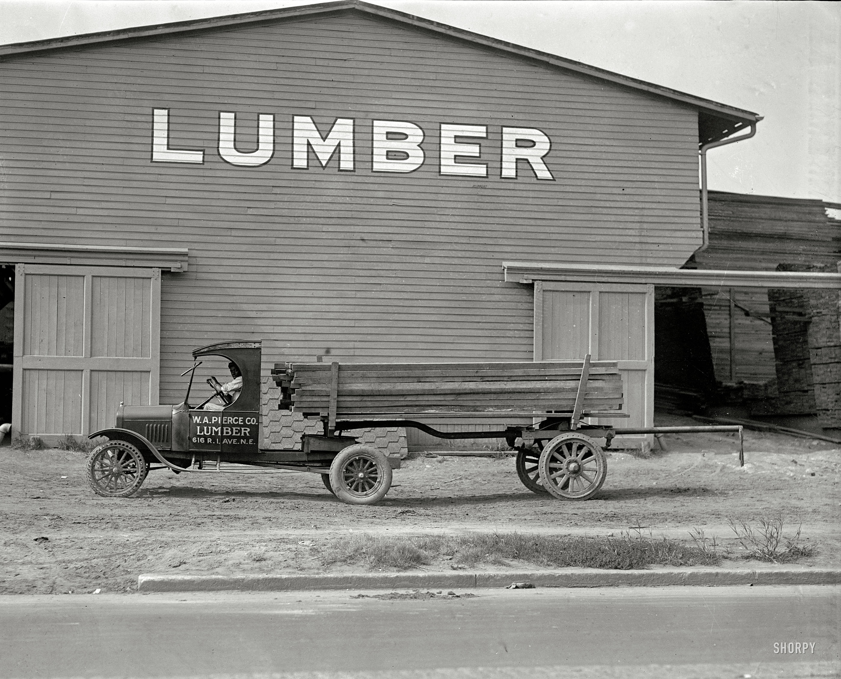 Washington, D.C., 1925. "Ford Motor Co. -- Pierce Lumber." An interesting mix of solid and pneumatic tires. National Photo glass negative. View full size.