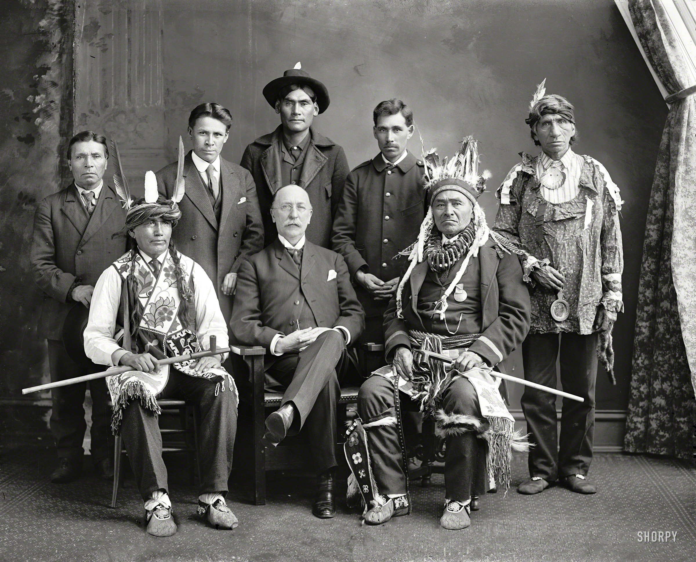 Washington, D.C., ca. 1900s. "Flatmouth, Chief, group." Chief Flatmouth, the formidable-looking gent seated at right, is wearing a medal that reads REDMEN'S CONVENTION, WALKER MINN., Aug. 12th 1901. The bald fellow and the Chief's lieutenants await identification. Harris & Ewing photo. View full size.