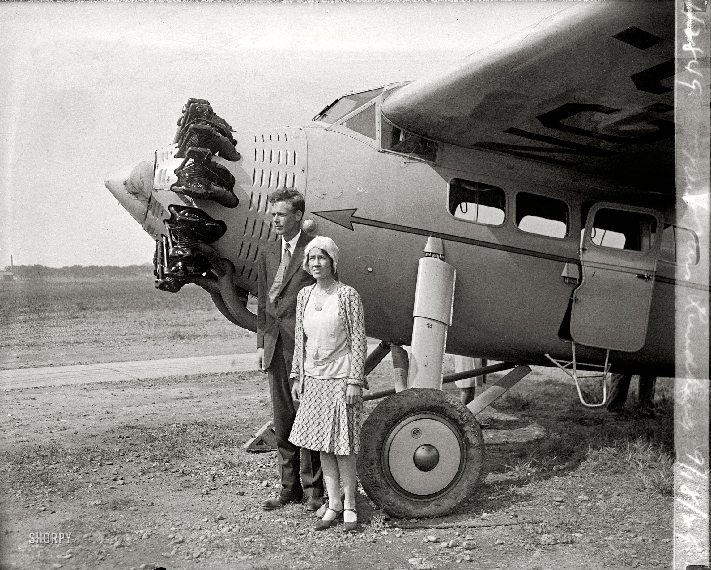 September 18, 1929. "Mr. & Mrs. Lindbergh." Aviator Charles Lindbergh and Anne Morrow Lindbergh, four months after they married, at Bolling Field en route to South America. Charles, the pioneering aviator, was probably the most famous person in America at the time; Anne would become an accomplished aviator in her own right, as well as one of the best-selling writers of the 20th century. Some three years after this picture was taken, the tragedy of their child's murder helped define the modern phenomenon of mass-media super-celebrity. From Anne's 2001 obituary in the New York Times: "Nothing, not even Lindbergh's 1927 landing in Paris, had prepared them for the carnival of reporters, photographers, con artists, curiosity-seekers, vandals and crazy people who invaded their lives after their baby was kidnapped. Americans would not experience a similar flood of publicity until the O. J. Simpson murder trial of the 1990s." National Photo Company Collection glass negative. View full size.