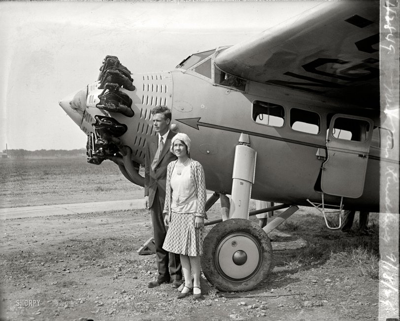 September 18, 1929. "Mr. &amp; Mrs. Lindbergh." Aviator Charles Lindbergh and Anne Morrow Lindbergh, four months after they married, at Bolling Field en route to South America. Charles, the pioneering aviator, was probably the most famous person in America at the time; Anne would become an accomplished aviator in her own right, as well as one of the best-selling writers of the 20th century. Some three years after this picture was taken, the tragedy of their child's murder helped define the modern phenomenon of mass-media super-celebrity. From Anne's 2001 obituary in the New York Times: "Nothing, not even Lindbergh's 1927 landing in Paris, had prepared them for the carnival of reporters, photographers, con artists, curiosity-seekers, vandals and crazy people who invaded their lives after their baby was kidnapped. Americans would not experience a similar flood of publicity until the O. J. Simpson murder trial of the 1990s." National Photo Company Collection glass negative. View full size.
