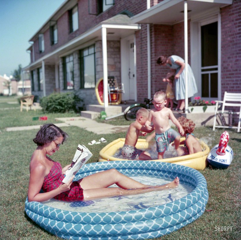 From 1954, and a world away from Lana lounging: "Woman relaxing in an inflatable swimming pool while her children play nearby in Park Forest, Illinois." Color transparency from a Look magazine assignment on life in suburbia. View full size.

