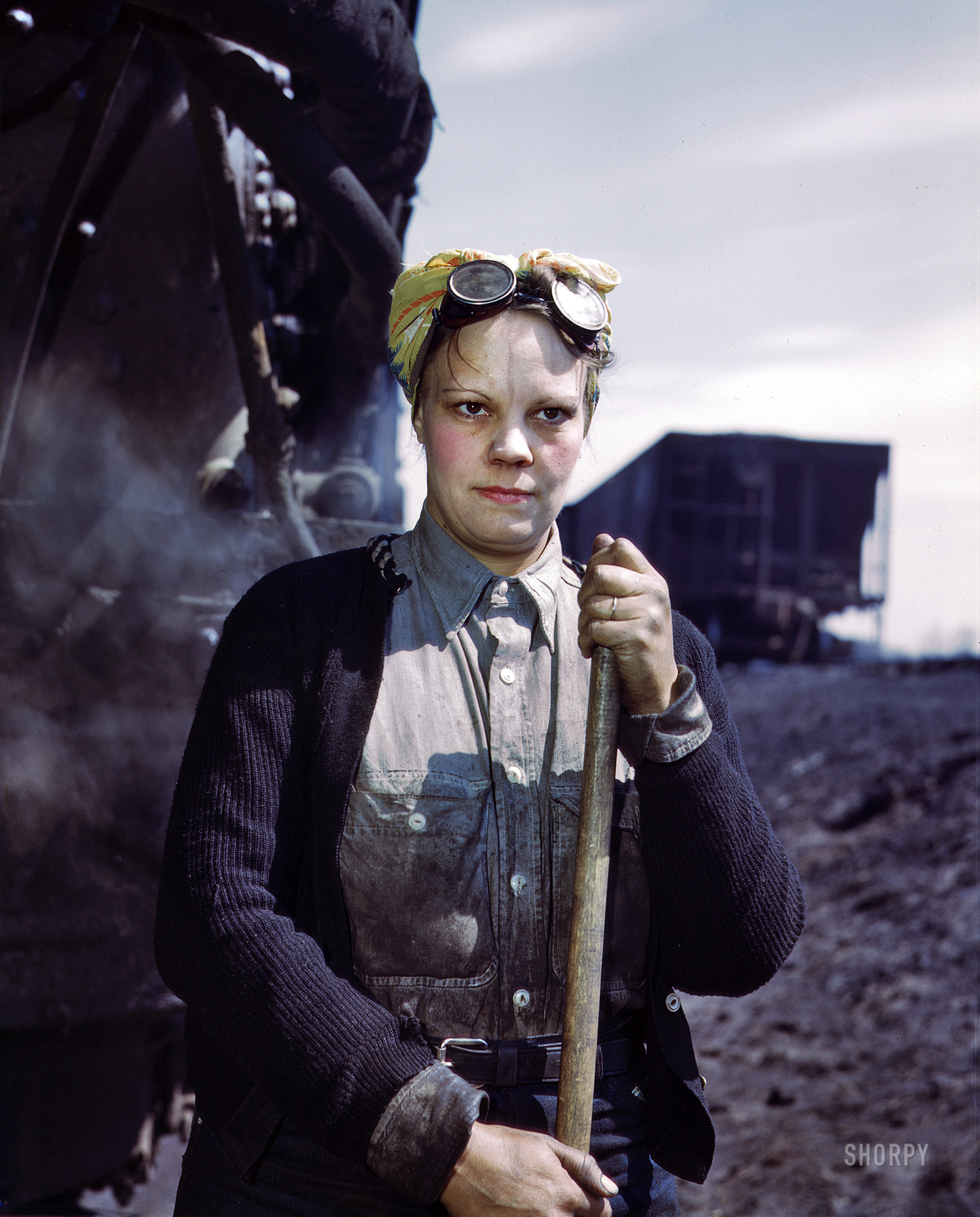 April 1943. Clinton, Iowa. "Mrs. Irene Bracker, mother of two, employed at the roundhouse as a wiper, Chicago & North Western R.R." 4x5 Kodachrome transparency by Jack Delano for the Office of War Information. View full size.