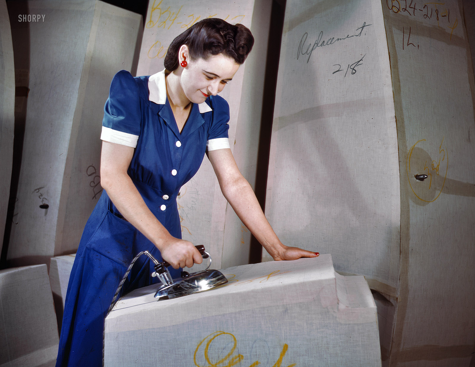 December 1941. Akron, Ohio. "Manufacture of self-sealing gas tanks, Goodyear Tire & Rubber Co." A patriotic ensemble of red, white and blue. 4x5 Kodachrome transparency by Alfred Palmer, Office of War Information. View full size.