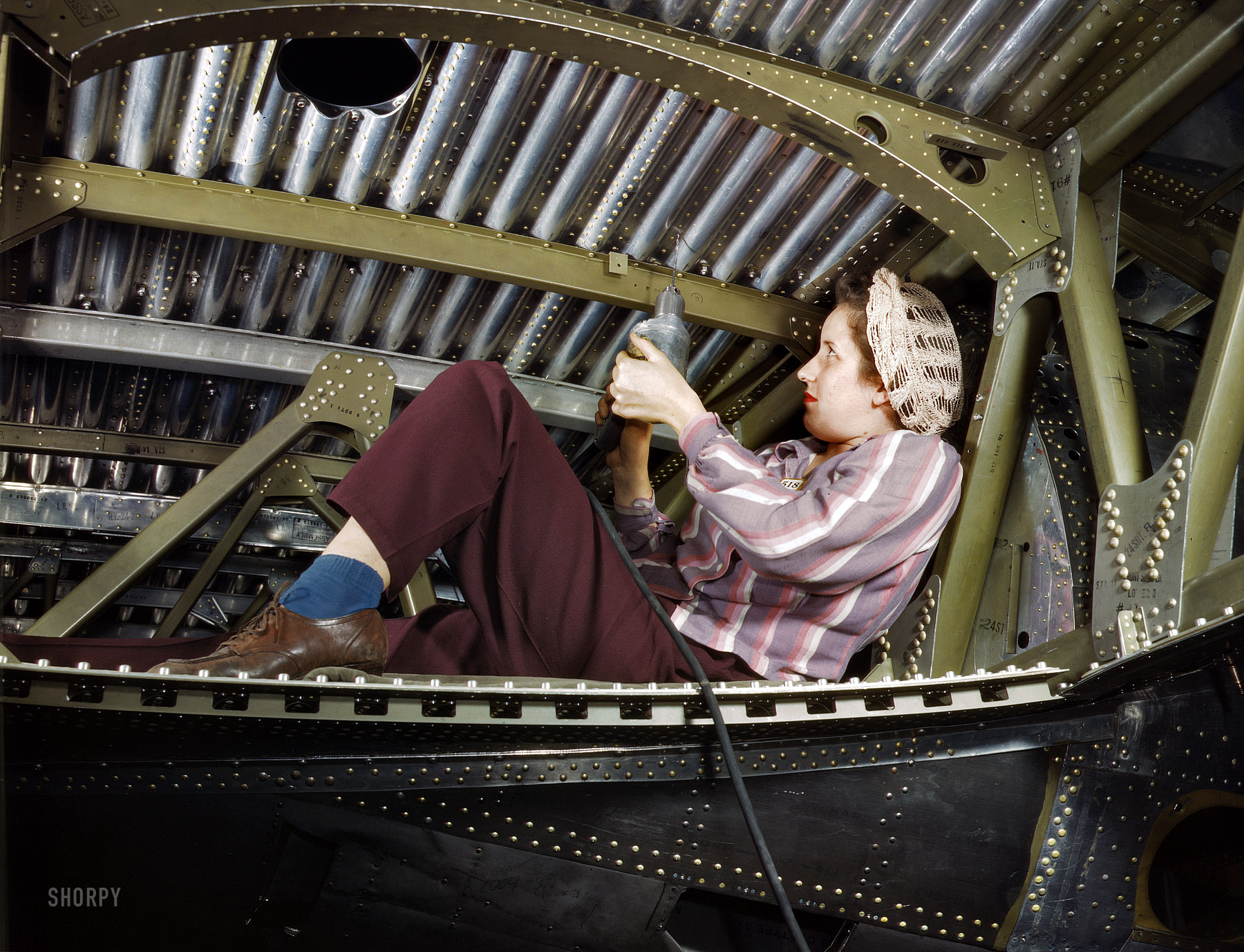 October 1942. "Douglas Aircraft plant at Long Beach, California. An A-20 bomber being riveted by a woman worker." (With, yes, a power drill.) 4x5 Kodachrome transparency by Alfred Palmer, Office of War Information. View full size.