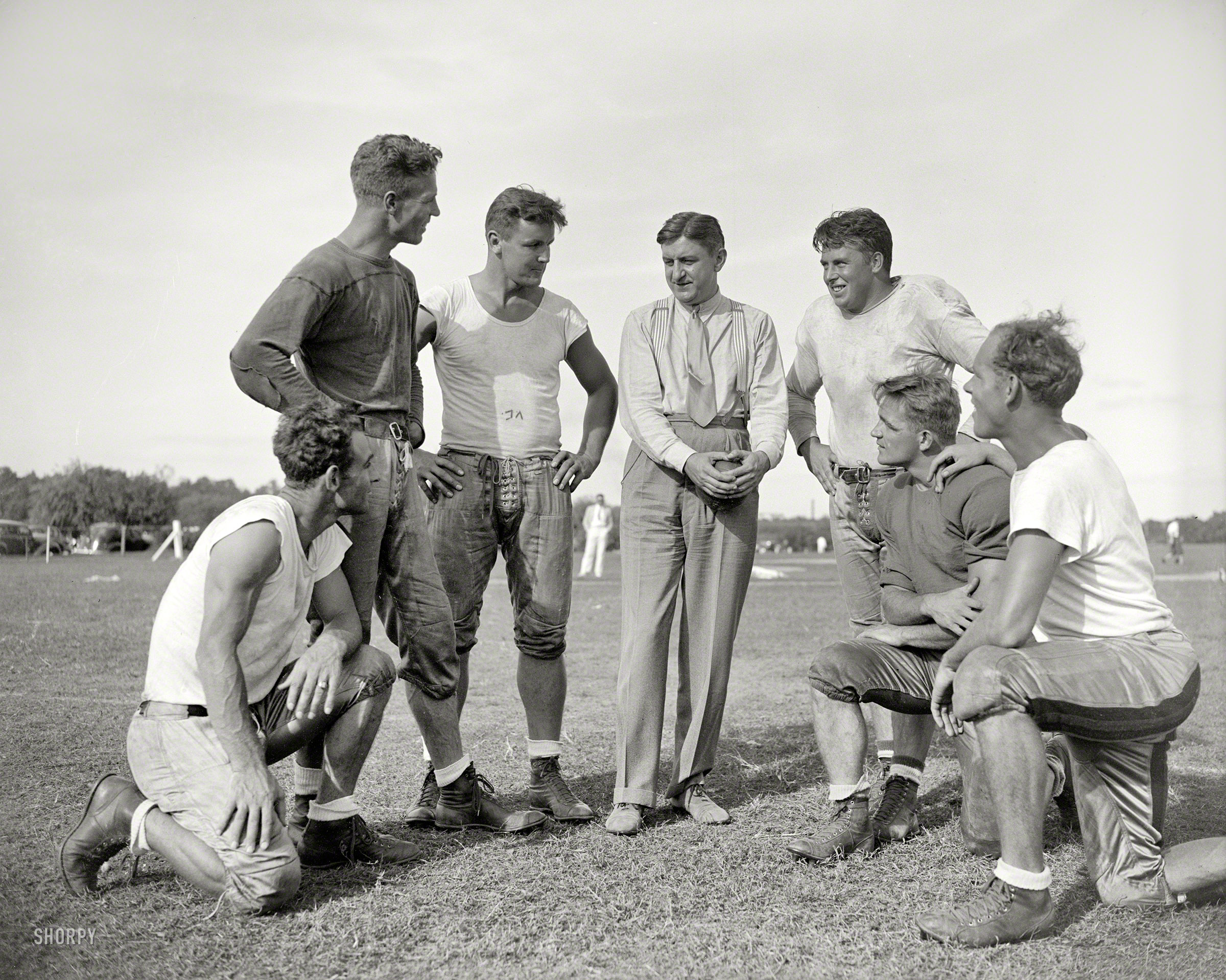 Sept. 11, 1937. Washington, D.C. "George Marshall, owner of the Washington Redskins, talks it over with some of his players, left to right: Wayne Millner, tackle, end; Charlie Malone, end; Vic Carroll, tackle; George Marshall and Bill Young, tackle; Ed Michaels, guard; Jim Garber, tackle." View full size.