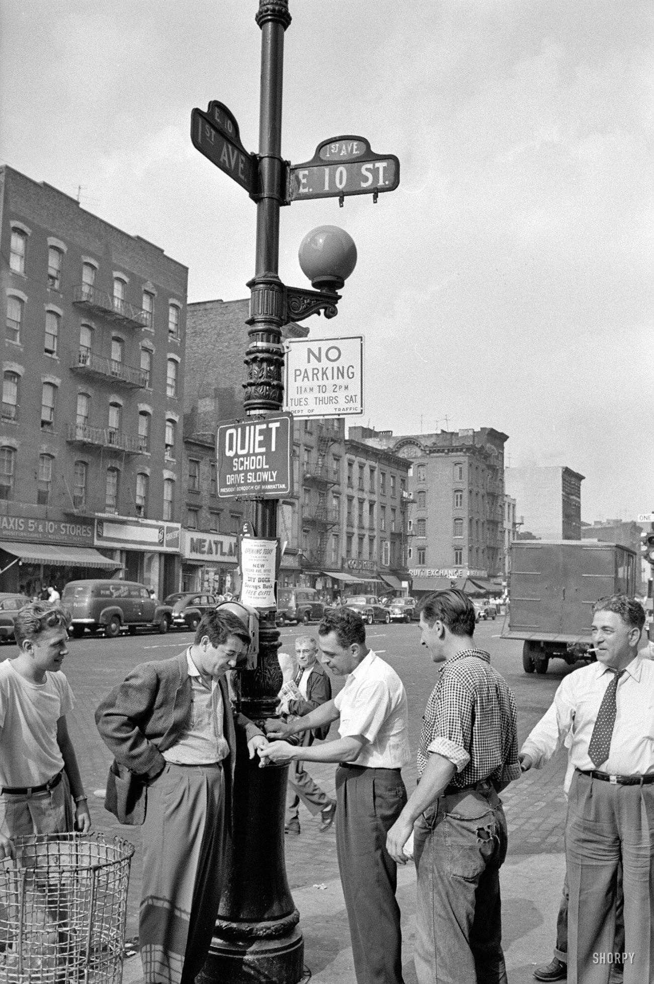 1954. "Boxer Rocky Graziano walking streets in New York with local boys." From photos for the Look magazine article "The Fight of My Life." View full size.