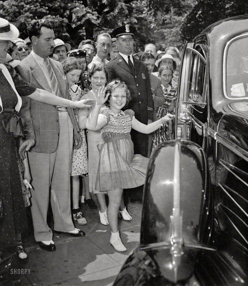 Shirley Temple Black, Screen Darling, Is Dead at 85
June 24, 1938. "Shirley sees her old friend the president. Shirley Temple leaving the White House today after a very important conference with the President. Shirley told Mr. Roosevelt about losing a tooth last night, and he told her about Sistie and Buzzie losing their teeth. Shirley expects to be in Washington a week checking on the affairs of state with different government officials." Harris &amp; Ewing Collection glass negative. View full size.
