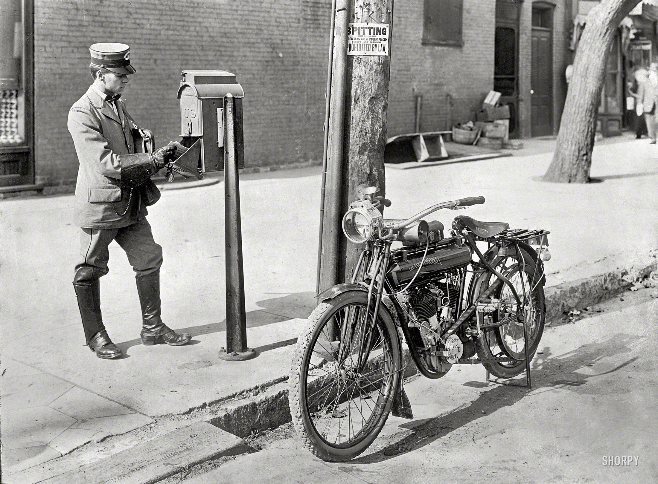 Circa 1915, location unknown. "Mailman & motorcycle." And not just any motorbike but a "Flying Merkel," with what looks like an acetylene-gas headlamp. Oh, and Spitting Prohibited by Law, "Except Into Cuspidors." View full size.