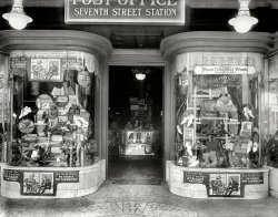 June 1920. "Berberich store window, Seventh Street." The venerable Washington, D.C., shoe emporium. In the era of confining footwear, bunions, corns and calluses, it was Dr. Scholl to the rescue. National Photo Co. View full size.
Shoe du JourDespite the date, some of those ads look oddly contemporary. Anyway I'm sad that I missed Foot Comfort Week. Maybe next June 21-26, 1920.
Weak claim.So, you get foot comfort this week -- then what happens?
Fashionable CrueltiesIn the 1920s American and European missionaries were quick to condemn the horrors of traditional Chinese foot binding, but our own shoe fashions were hardly more rational, and Dr. Scholl made a fortune providing remedies to ease the pain of wearing the "beautiful" pointed shoes that deformed our feet. Many people today still think that those vintage shoes look prettier than shoes shaped like real human feet, even if we don't wear them, and that undeformed "peasant" feet with anatomically normal wide toes are somehow low-class. The architect and social historian Bernard Rudovsky (1905-1988) famously called these beliefs into question in his 1947 exhibition "Are Clothes Modern?" at the Museum of Modern Art in New York, with his model of a human foot that fit our symmetrical shoes by putting the big toe in the middle.
Adding Insult to InjurySo we have to wipe our corn and bunion covered, crooked-toed feet before entering your establishment?  Gee thanks Mr. Berberich.  
Soon to comeI don't see the Zino-Pad and I searched the pic as close as I could. It was invented by Dr Scholl in 1918 for corn removal, but probably wasn't in full distribution by 1920.
Small feetI've heard that women used to be ashamed  of larger feet and would buy shoes smaller than really needed.  I've evidenced this in many of the photos of the 20s - they always seem to have "foot pillows" popping out the top of the foot!
History RepeatsThe clerk-in-charge of the Seventh Street (Post Office) Station, located in Berberich's at 1118 7th Street, NW, was Leona M. De Lawder.  The post office's hours were 8am to 6pm, closed Sundays and holidays.
Interesting that the USPS, in wanting to close down free-standing post offices, is looking at the contract station inside of established business model.
Shoe Store FluoroscopyI remember, during my childhood in the 1930s, my mother taking me to the local Thom McAn shoe store. Before she invested the four or five dollars in a pair of shoes that I would soon outgrow, I would stick both feet into the console fluoroscopy machine, prominently situated at the front of the store. There were 2 viewing ports not unlike those on the hand cranked Nickelodeon machines. I looked through one of those ports, to see my toes wiggling in the X-ray machine's green light. My mother and/or the salesman taking turns looking through the other viewer to make sure I had plenty of room for those toe bones to grow. These devices would be around until the 1960s, when the Feds, realizing the X-raying dangers banned their use.
Oh my goodness willc!  I sawOh my goodness willc!  I saw that exact display at an exhibition at the Cooper Hewitt in NY in the mid-1980's.  I've never forgotten the shape the foot with the big toe in the middle.  Too funny.
A quick walk back on memory lane.This shoe store looks almost exactly like the one I remember from my childhood:  Slosberg's in Gardiner, Maine.  I can close my eyes and drift back to those days when I would walk into the store, and breathe deeply; taking in the smell of shoe leather and pipe tobacco (Mrs. Slosberg's husband smoked a pipe).  I distinctly remember that Mrs. Slosberg always tended the customers; and her husband went and found the shoes on the racks on the walls that, while only about 20 levels high, seemed like a hundred.  She would give each child a hug, sit them down, take their shoes off them, and massage their feet to get them loosened up to the right shape and size for proper fitting.  I always felt like some kind of royalty with the way I was treated.  I also remember having to put my old shoes back on to leave the store, as my mother didn't want me scuffing up the new ones.  Somehow, today's experience in buying shoes just isn't quite the same.
(The Gallery, D.C., Natl Photo, Stores & Markets)