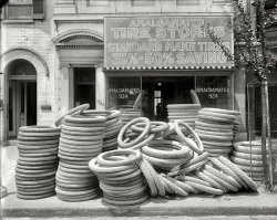 Washington, D.C., circa 1920. "Amalgamated Tire stores, front." Our second glimpse of this fine establishment. National Photo Co. View full size.
Tire GlutI'm wondering if this is evidence of the worldwide drop in the price of rubber, which led to huge inventories purchased earlier at a much higher price; in 1921, Goodyear was completely restructured and almost went belly-up as a result.
I&#039;d love to see the bicycles those went onOh, wait, those are car tires!
From what I can see:Those tires are 100% off.
White rubber tires?I've often wondered whether the old plates were responsive to near-infrared light, especially since all the tires in this photo appear near-white.
Carbon black was incorporated into rubber compounds in 1910, mainly to improve wear resistance. Maybe these tires are examples of the hold-over design, hence the discount prices.
(The Gallery, Cars, Trucks, Buses, D.C., Natl Photo)