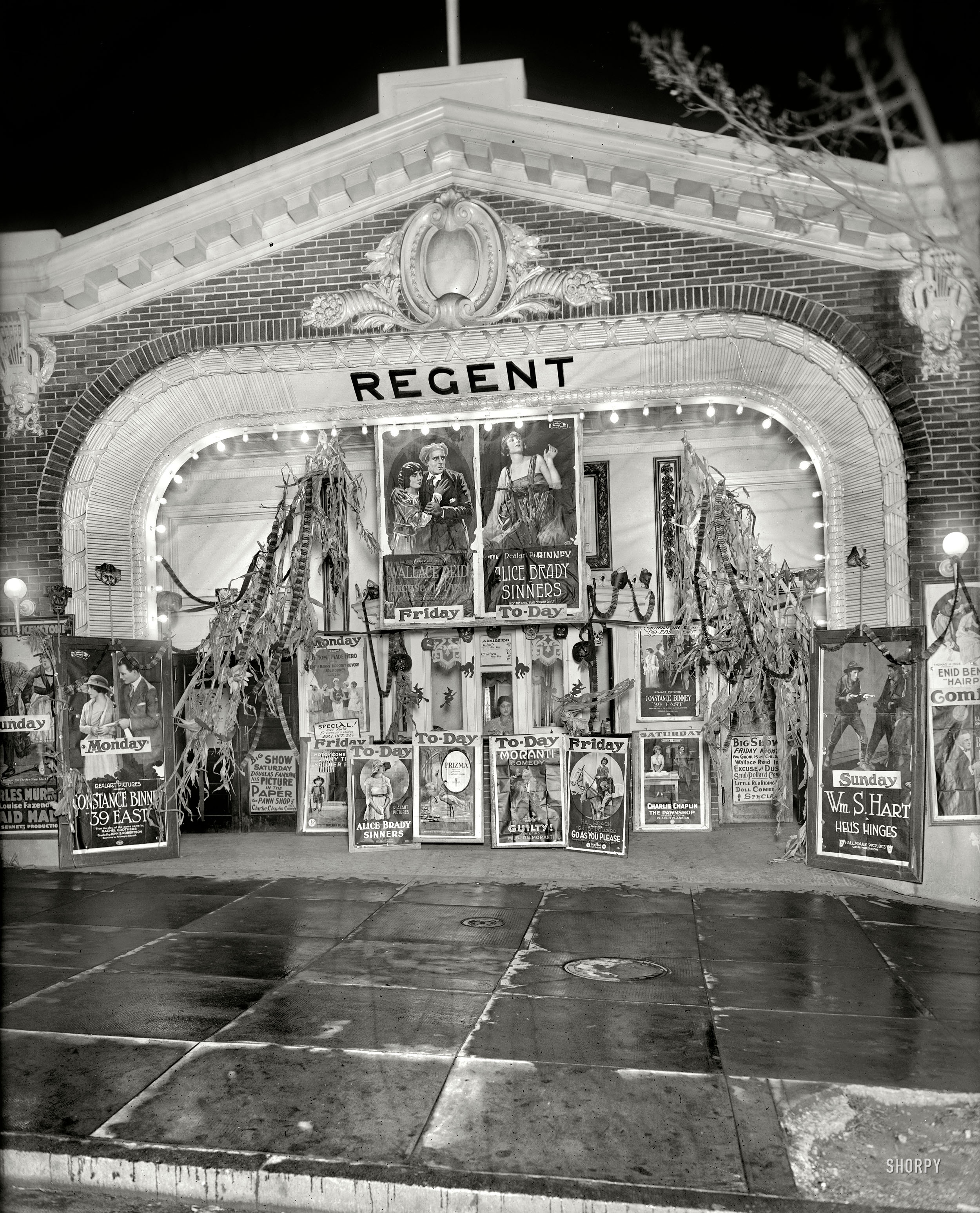 October 1920. Washington, D.C. "Lust's Regent." Theater impresario Sidney Lust's 18th Street cinema decorated for Halloween with an array of eye-catching movie posters. National Photo Co. glass negative. View full size.