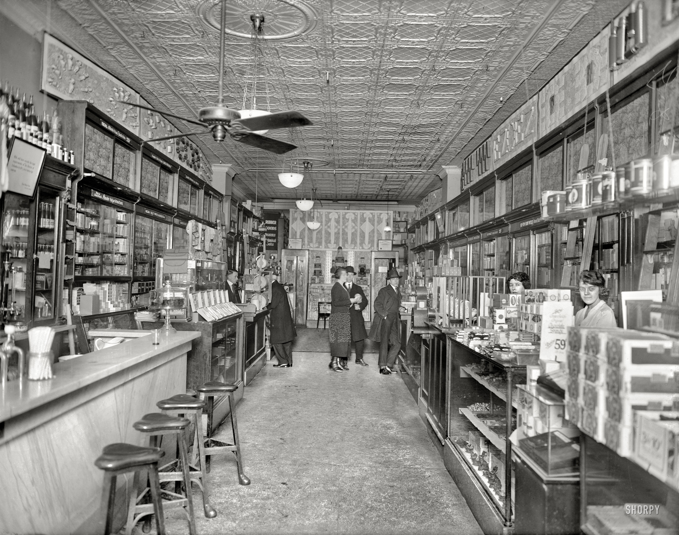 Washington circa 1920. "People's Drug Store, interior, 11th & G streets." In the Rubber Goods section in back you'll find the inevitable "trusses and abdominal belts."  National Photo Company Collection glass negative. View full size.