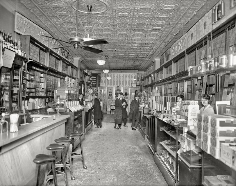 Washington circa 1920. "People's Drug Store, interior, 11th &amp; G streets." In the Rubber Goods section in back you'll find the inevitable "trusses and abdominal belts."  National Photo Company Collection glass negative. View full size.
