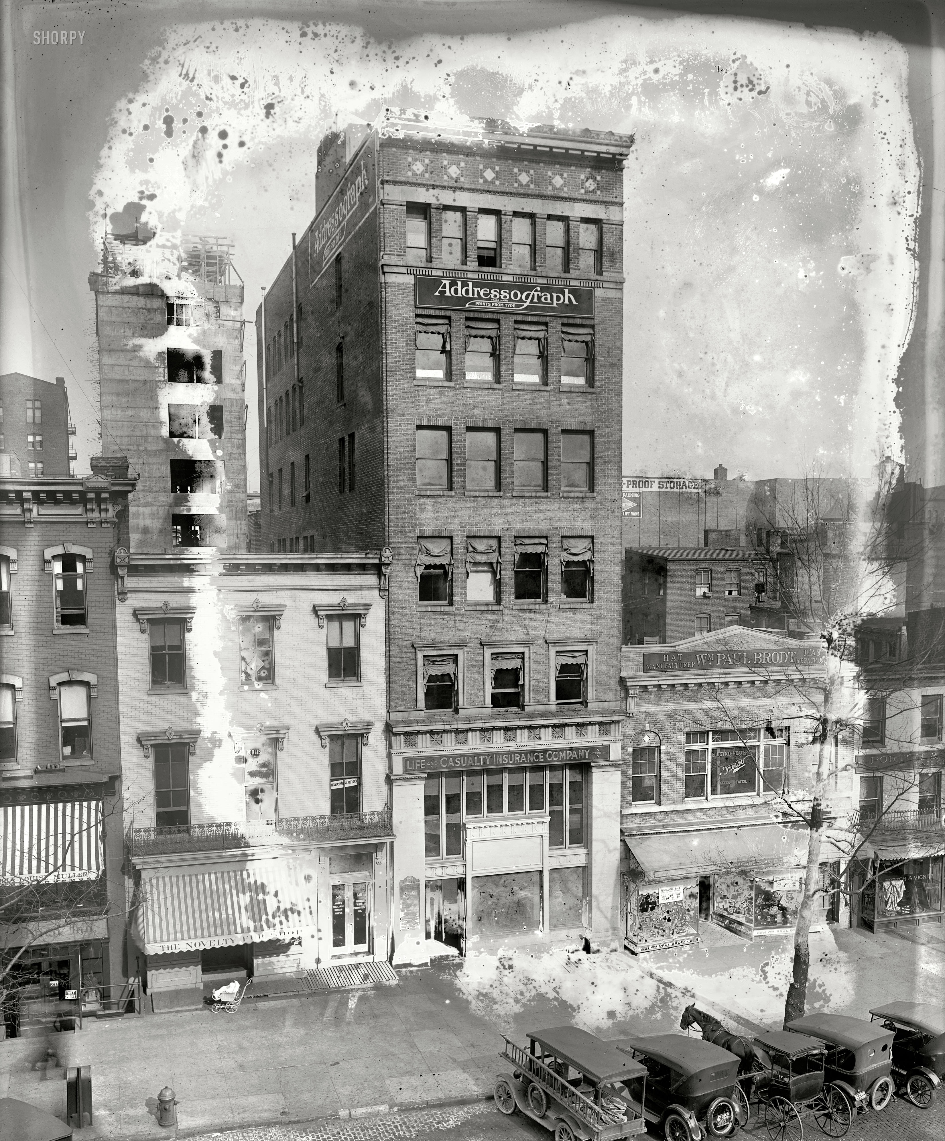 Washington, D.C., circa 1923. "Addressograph, 11th Street." I had written this off as too moldy to post, then saw the horse parked among the cars and baby parked in front of the fur store (is one baby-sitting the other?) and decided they deserved their 15 minutes of fame. National Photo glass negative. View full size.