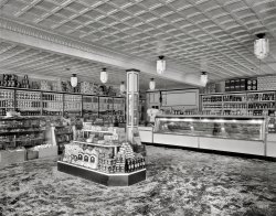 Washington, D.C., circa 1935. "Interior of D.G.S." The District Grocery Store at Seventh and E streets S.W. You'll come for the savings and stay for the sawdust! 8x10 acetate negative, National Photo Company Collection. View full size.
I&#039;m not cleanin&#039; that up!I remember as a kid that we would spend our time "ice skating" around the floor at the local butcher  while mom shopped. But then again, we did not have a large crate of eggs on the floor!
Egg PressureWho knew you could pile eggs that deep without breaking the ones on the bottom.
Sawdust on the floorsCommon use for sawdust in grocery stores/butcher shops (and bars) was to absorb dirt and liquids and thus easier to clean up. Does not sound very sanitary and is probably one reason its use being discontinued... and needless to say fire marshalls had something to do with stopping this practice too. 
Brings Back MemoriesI remember going to the grocery store with my mother and she would buy her meat from a display just like this one.  There would be someone behind the counter and Mother would make her selection.  The worker would weigh it, then wrap it in white paper, and place the price on the paper.  I remember how strange it was when she began to select her own prepackaged meat from an open display.  
Campbell&#039;s Soup Can GeniusIn this form of grocery store you can see the genius of Campbell's can labels.  Very distinct as they line the back walls of the store.
Sawdust and TabsI have a dollar with me so I'll have a box of Rice Krispies, Hershey's Cocoa, a box of Milk Bone and some Oxydol.
Oh wait a minute. Those cakes look good too. I'll take one of them and put the total on my tab.
I am old enough to remember sawdust floor supermarkets, but just barely. My grandmother lived in Brooklyn, New York City and had a supermarket named Packers which did that. They cleaned up their floors by the late 1960's.
She also had a corner grocer with a store like this. He had no sawdust but he did run a tab. When she wanted to watch her boring soap operas, she would send me to that corner grocer to buy a pint of ice cream. By the time I walked to the corner, picked a flavor, they wrote it down, gave me the box, and I walked back to her apartment, got a spoon, and ate it, the soap opera was over. It was a very smart way to shut a 5 year old up.
Washington FlourWilkins-Rogers Milling Company was located on the Georgetown waterfront. The building was converted to condominiums in the 1970's, but the company lives on with a mill in Ellicott City, Md.
In the 1950's, four brands were advertised together under the banner "Home Town Products." They were Washington Flour, Wilkins Coffee, Mann's Potato Chips and Schindler's Peanut Butter. Later, Wilkins Coffee TV commercials brought the Muppets early fame.
Light fixturesI imagine those would bring a few bucks on eBay these days!
Deco-catessenLove those art deco light globes, as well as the very precise and graphic regimentation of all the cans and bottles on the shelves -- I think Busby Berkeley may have had a hand in "staging" that display.  Also, if Oxydol will consider reviving that art moderne package now, I'll take a whole case!   
corner marketI well remember sliding around on the saw dust with my mother chatted with the butcher. As well as the free bologna slice.And the produce man washing the field dirt off the vegetables in a big white claw foot bathtub in the stock room.
I think they could stack lose eggs deep in a box like that because the shells where thicker back then. The broken wasted eggs I see in "protective cartons" at the market nowadays is amazing, what a waste.
Hey, I found the white bread, but I don't see were they put the chips and salsa!
Re:  Campbell Soup CansFor rich.n  If you did not know this, there is currently a limited selection of their tomato soup with four different Andy Warhol repro labels in the exact colors Warhol used in his famous artwork which is quite unique.  I found mine at Target but don't know who else carries them.  Very nifty to display in your kitchen, just FYI.
P.S. I don't know how long their shelf life would be.
Where&#039;s My Shopping List?Wow, I'm surprised to see that Bisquick and Milk-Bone were aound back then.  Bisquick seems lke such a 60's product.  The Hershey's Cocoa box hasn't changed much.
It must have been a headache to keep all those cans and rows so straight and perfect.
Elf rising. Elf rising (paper sacks). What does it mean? Uprising? Opressed elves uprised? It sounds funny for me, really.
[Self-rising flour. - tterrace]
Got Pep??Beautiful place to do your grocery shopping, everything is neat as a pin...except one item. One box of Kellogg's Pep cereal is upside down. And to the "elf rising" comment all I can say is this, surely(hopefully)that was not a lagitimate question.
Hey I&#039;m not that oldAnd I remember sawdust on the floors of the supermarket! (At least on rainy days.)  Specifically Market Basket in Massachusetts, in the 1990s. It was always such a mob scene there, it was my least favorite place to go shopping as a kid. They don't have sawdust on the floors anymore but the stores are still wonderfully low fi and retro in style. They haven't updated the employee 'uniforms' since the 1970s at least. 
Is that lye I spy behind the bakery counter? And penny candy on the far end of the island?
(The Gallery, D.C., Natl Photo, Stores & Markets)