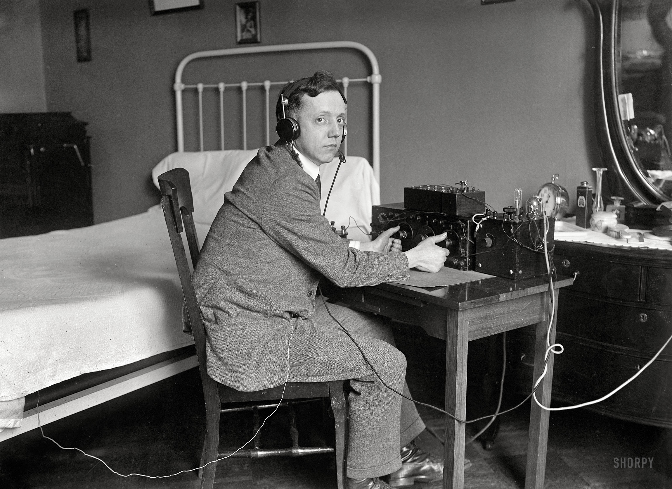 March 31, 1922. "H.G. Corcoran of Washington, D.C., needs an aerial for his radio outfit. His receiving wire is connected to the wire springs of his bed, which take the place of an aerial." Harris & Ewing Collection glass negative. View full size.