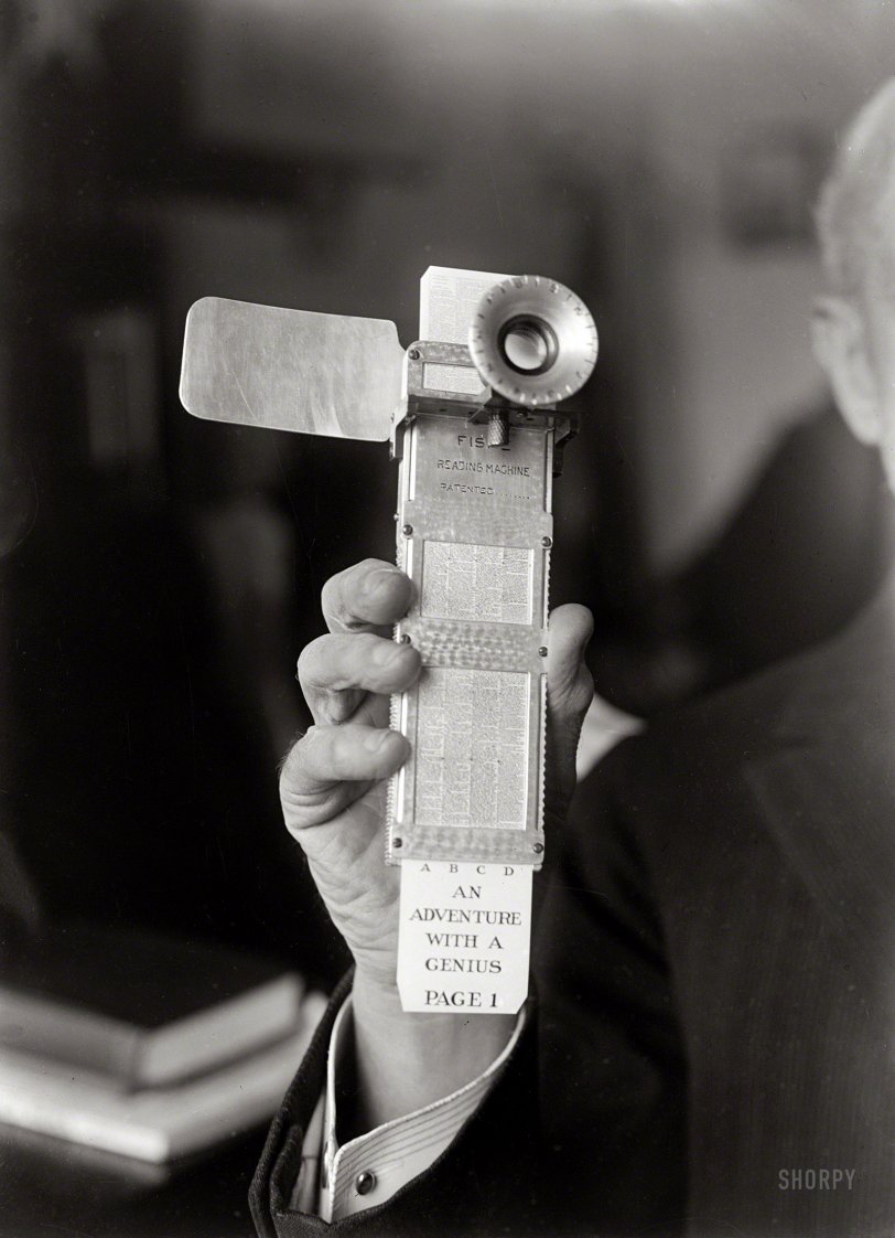 Circa 1922, the Fiske Reading Machine in the hand of its inventor, Rear Admiral Bradley Fiske. Where's the Home button on this thing? View full size.
