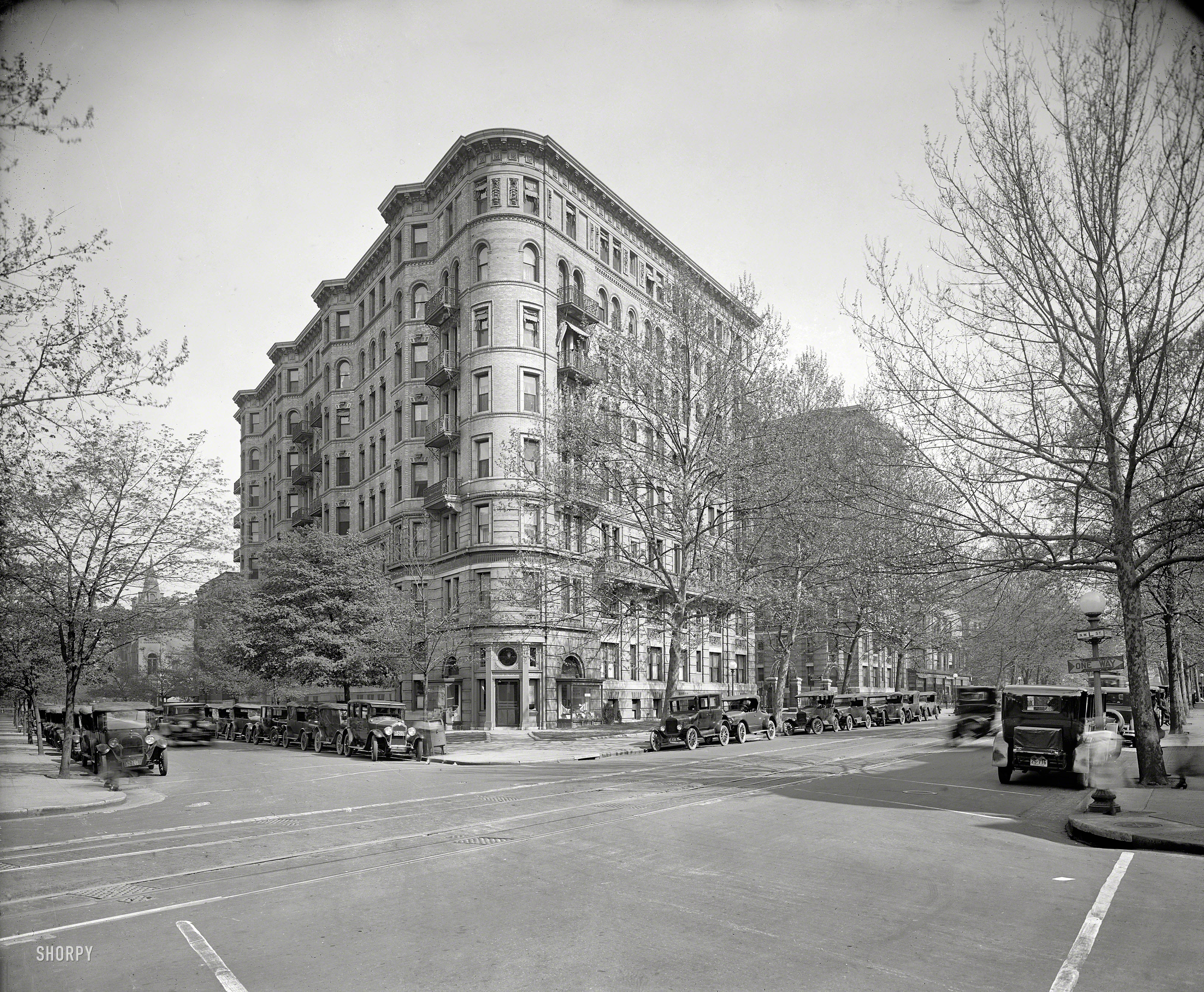 Washington, D.C., 1925. "Stoneleigh Court apartments, L Street and Connecticut Avenue N.W." Close inspection will be rewarded with a wealth of detail afforded by this 8x10 glass negative, the highlights including disembodied pedestrian parts captured in mid-stride, and perhaps the earliest appearance on these pages of a ONE WAY traffic sign. National Photo Company Collection. View full size.