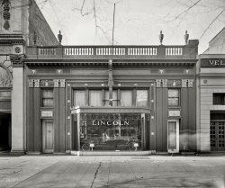 Washington, D.C., circa 1925. "Exterior, Warfield Motor Co." The Lincoln dealer whose service garage we recently saw here. In 1927 the company moved next door into the building on the left. National Photo Co. View full size.
Well-Nigh Faultless Performance


Washington Post, October 25, 1925.

If you have owned fine cars, you will appreciate the service we put back of the Lincoln. Competently trained mechanics &mdash; possessing a complete understanding of the car, and working with Lincoln designed service tools, handles the work quickly and expertly. 

Your car is inspected periodically with absolute thoroughness &mdash; and for the first four months there is no charge for this. As a consequence you enjoy at all times the well-nigh faultless performance of this superbly designed and built automobile. &hellip; 

Warfield Motor Company
1132-1134 Connecticut Ave.


PhotographerOne of the few times we get to see the photographer of the photo being taken at the same time.  Pretty cool! 
InterestingThat's an interesting phantasm to the right...someone skipping along and stopped?
[The exposure stopped, not the ghost. -tterrace]
(The Gallery, Cars, Trucks, Buses, D.C., Natl Photo)