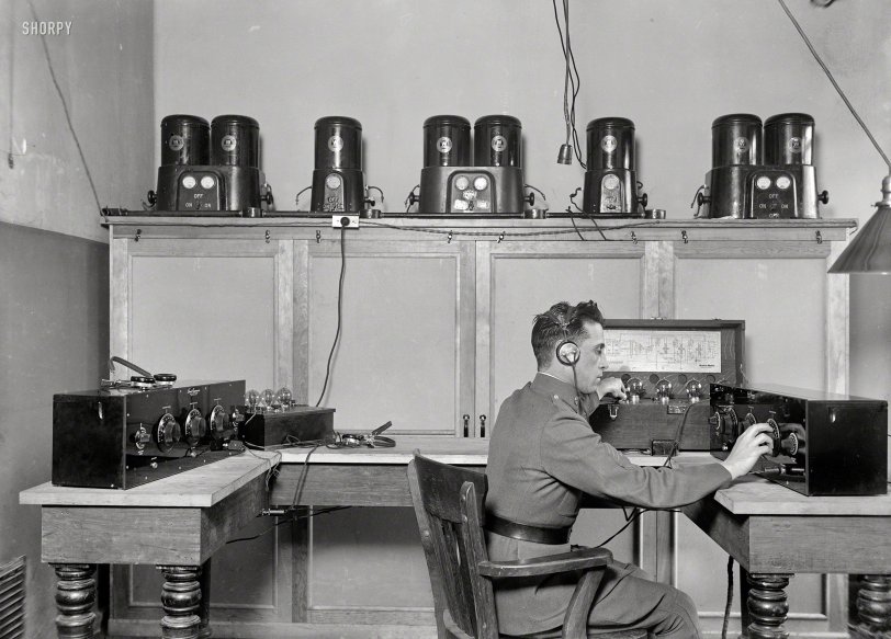 Washington, D.C., 1924. Tweaking the dials on a Freed Eisemann Neutrodyne receiver and a Western Electric 138 amplifier. On the shelf: Westinghouse "Rectigon" battery chargers. Harris &amp; Ewing glass negative. View full size.
