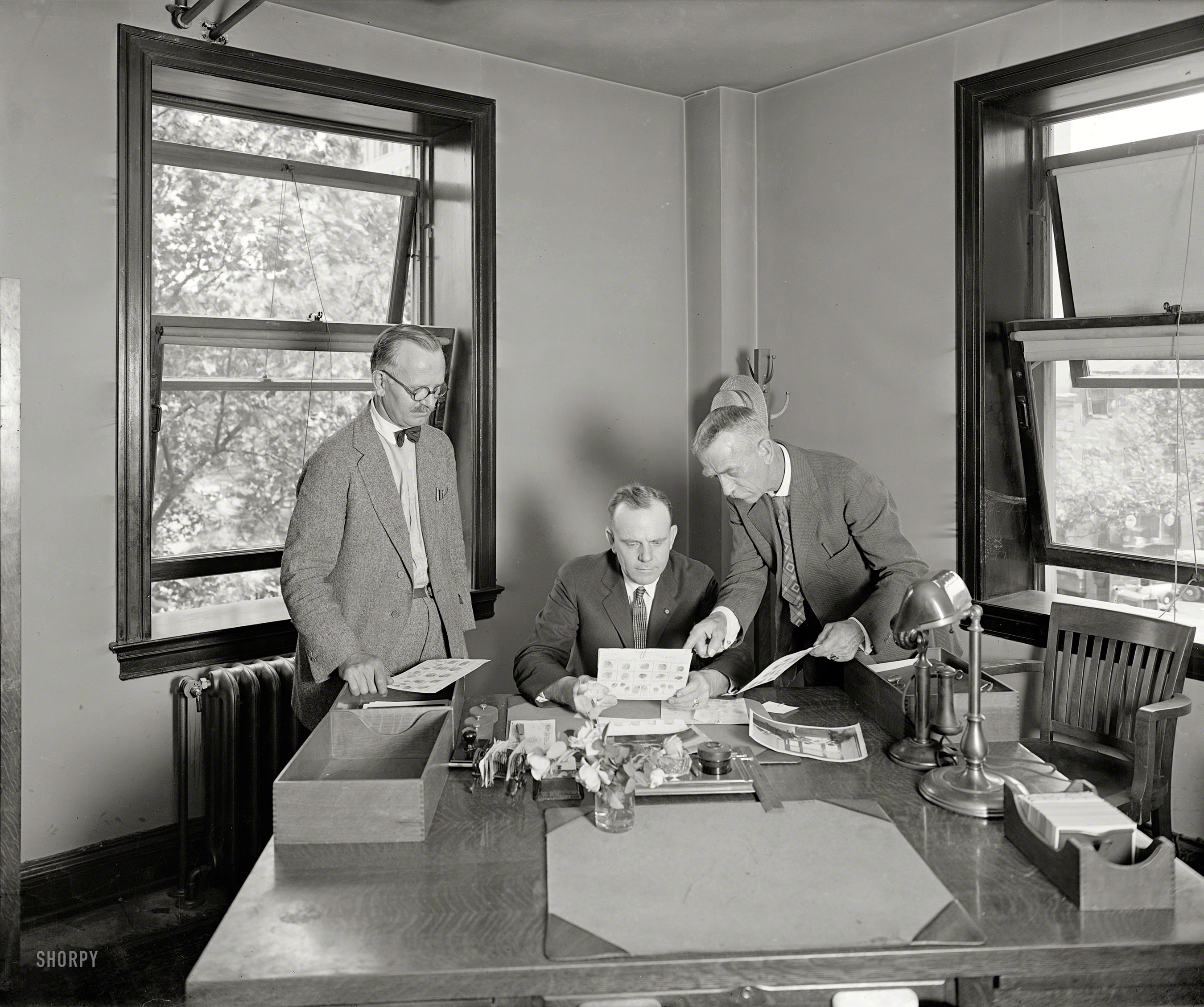 June 1926. "Bureau of Identification, Department of Justice, Washington." Poring over fingerprints at the forerunner of the FBI. National Photo Co. View full size.