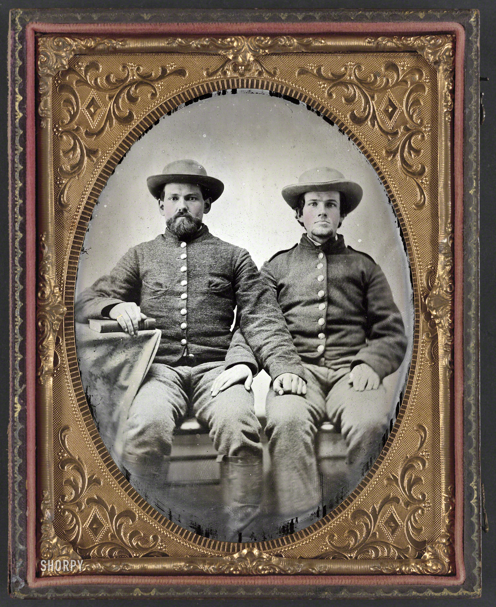 1861-65. "Pvt. Charles Chapman of Company A, 10th Virginia Cavalry Regiment (left), and unidentified soldier." Half-plate ambrotype, hand-colored. Liljenquist Family Collection of Civil War Photographs, Library of Congress. View full size.