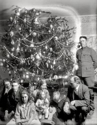 &nbsp; &nbsp; &nbsp; &nbsp; The spherical tree, the scattershot expressions, the faint undercurrent of anomie and alienation -- yes, it's our annual holiday dispatch from the family of Washington, D.C., lawyer Raymond Dickey, who has a decade's worth of Christmases preserved in the archives of the National Photo Company. Their 1918 portrait, with an Army surgeon and map of World War I Europe, is even more dire than usual.

"Dickey Christmas tree -- 1918." 8x6 inch glass negative. View full size.