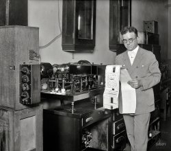 Washington, D.C., 1927. No caption on this Harris &amp; Ewing glass plate of what seems to be facsimile equipment. View full size.
PhotoradiogramPhotoradiogram was one of the first facsimile devices, according to this wiki article about Richard H. Ranger, its inventor.
Fax is older than you might think...Here's some of the history of fax:
http://www.hffax.de/html/hauptteil_faxhistory.htm
Motors, Gears and WormdrivesLet me stick my hand in there to clear that debris.
How I read itHere's is my reading of the message miracle of the 20th century:
2 FBZ VLARK
Msg for Comdr Le
Clair  When may we
expect Seattle to
transmit test picture.
It appears to me the
usefulness of further trans-
mitting by us is questionable
and unless you can send
tests may as well be
suspended. Biere
[Here's a close-up. -tterrace]
Thanks to stanton_square and tterrace for helping to fill in the blanks.
Naval CommunicationsA curious oddity of a photo staged to demonstrate the marvel of a new widget containing a message which questions the usefulness of the same device.  I guess he didn't expect the photograph to resolve the text. The February 13, 1927 Washington Post reports the imminent promotion of a Lt. Comdr. Hugh P. LeClair.



Washington Post, May 24, 1927.

New Radio Service Utilized by Navy


Photoradiogram is Sent by Admiral Eberle
to Maneuvering Ship.


A new experimental radio service in the Navy was opened yesterday by Admiral E.W. Eberle, chief of naval operations, who sent the first official message over the new photoradiogram apparatus installed recently at the Navy Department to the similar one on the U.S.S. Seattle, flagship of the United Sates fleet at Newport R.I.

His message to Admiral Charles F. Hughes, fleet commander, stated &#8220;this first message by photoradio transmission between the Navy Department and the flagship of the commander in chief, engaged in maneuvers off the New England coast, begins a service which it is hoped will have a far reaching effect on naval communications. &#8221;

A copy of the message as received showed that some of the words were missing due to the other radio impulses, but great hope is held for conversion of the commercial apparatus to naval use.

Nervous Fountain PenI'm continually impressed by the quality of technical writing in the newspapers of the time. The box on the left with the four dials is a decade resistance box, perhaps used for tuning.  



Washington Post, October 18, 1925.

Photoradio New RCA Development


Means for Transmitting the Actual Events to Listeners-In.


&#8220;Photoradio&#8221; means the sending of photographs or other pictures by means of a radio transmitter to a distance, and receiving these wherever suit suitable apparatus may by located. Thus, like broadcasting, a million persons could receive the same picture at the same time, provided only, again as in broadcasting, that they possessed suitable apparatus for this work.

Now, photoradio is not by any means &#8220;tele-vision.&#8221; By the latter we mean the equivalent of &#8220;radio moving pictures,&#8221; or, more exactly, the ability to see, by radio, some distant event just as it would appear to the eye of some one near it at the moment. Photoradio is the first step toward the attainment, perhaps not so many years in the distance, of real tele-vision, but it admittedly is but a first step. 

In the Radio Corporation of America's system, a photograph is taken of whatever scene of person's face or printed page, or other picture one may desire to transmit. This negative is placed in a special device, and by means described in detail in later paragraphs, the lights and shades of this picture are sent, square inch by square inch, in the form of high-speed dots sent out by a radio transmitter. At the receiver, or as many receivers as may be in operation, the received dots actuate a relay, and this, in turn, causes a &#8220;nervous fountain pen&#8221; to print on a paper record, dot by dot, identical as to shade and position, the impulses sent out from the sending station. Thus, in time&mdash;it takes about twenty minutes for an ordinary photograph&mdash;the entire picture is transmitted and received. 

The entire process depends essentially on three factors. First, the ability to control a radio transmitter by different degrees of light passing through a negative or other screen. This is found in the &#8220;light sensitive cell,&#8221; a device which will allow electric current to pass through it when light is shining on its electrodes, and which shuts off this current the moment light ceases. Second, a method for having radio currents control a relay. The radiotron, or vacuum tube detector, does this. A relay placed in its plate circuit will respond when incoming signals affect its grid, and of course any other electric circuit that we may desire. The third requirement, and the most difficult one to attain, is the exact synchronism of the speed of the carrier for the transmitted negative and the carrier for the received record.
RadiofaxRadiofax weather charts for the benefit of ships at sea are still broadcast worldwide by organizations like the NOAA and the Deutscher Wetterdienst. 
(Technology, The Gallery, D.C., Harris + Ewing)