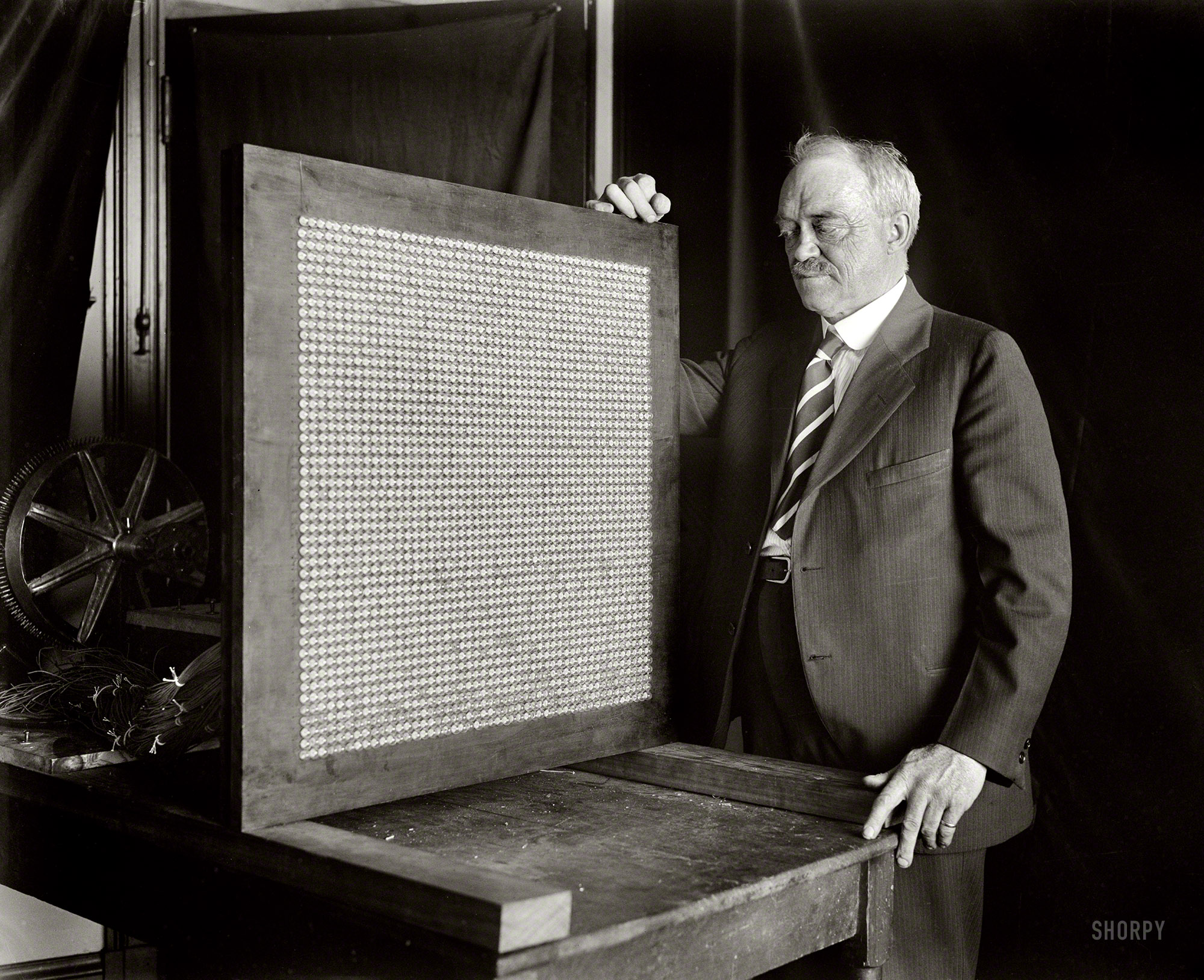 JoeH has identified the mystery man as Washington inventor and television pioneer Charles Francis Jenkins (1867-1934), pictured here with what might be considered an early flat-panel video display, its 48-pixel-square grid composed of small neon lamps.
Washington, D.C., in 1928. "NO CAPTION" is the caption for this one; again we turn to the crowd-source wisdom of the Shorpy masses to inquire: What the heck is it? (Close-up here.) Harris & Ewing Collection glass negative. View full size.