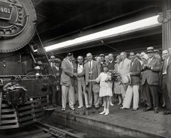July 14, 1929. Washington, D.C. "Ten-year-old Ellen Page Eaton will break a bottle of Potomac River water on the locomotive of a new Pennsylvania Railroad train this morning at 11 o'clock in the Union Station and christen it 'The Senator.' Little Miss Eaton is the daughter of John Eaton, crack engineer of the railroad, who is veteran of 28 years." More of the festivities first glimpsed here. Harris &amp; Ewing Collection glass negative. View full size.
Ready when you are, CBIt looks like this might not have been the first take.
WhoopsYeah, looks like that Potomac River water didn't quite make it to the locomotive! Oh well, the thought was there. 
Shoes and aplomb!I like the gent to the right of little Ellen Page Eaton, holding his hat with aplomb and trying become the center of attention.  And look at his fashionable shoes!
As Jimmy Durante would say"Everybody wants to get into the act." The woman behind Miss Eaton and to her right in the picture is quite intriguing. And lovely. And elegant in her cloche hat and beads. The only thing prettier than a pretty woman is a pretty woman with a pretty hat. 
Senator David I. WalshThe gent at the left-end shaking hands looks to be Senator David I. Walsh, of Massachusetts. Below is the final bit of the article from the previous post. 



Washington Post, July 14, 1929.

&hellip; Among those who will attend the ceremonies are Senator David I. Walsh, of Massachusetts, District Commissioner Proctor L. Dougherty, Charles W. Darr, president of the Washington Chamber of Commerce, and the Rev. Shera Montgomery, chaplain of the House or Representatives. Alan B. Smith, general passenger agent of the railroad, who came here from Cleveland on July 1, is in charge of arrangements. Secretary of the Navy Charles Francis Adams and Secretary of Commerce Robert P. Lamont also have been invited to attend.

[The man between the hand-shakers is Charles Darr. - Dave]
(The Gallery, D.C., Harris + Ewing, Railroads)