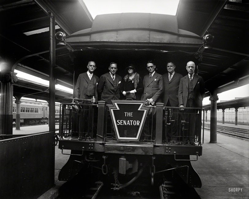 UPDATE: The photo now has a caption.
October 1, 1929. The new crack train from Washington to Boston was inspected today by members of the Massachusetts State Society. Harry Carr of the Pennsylvania R.R. was host. Left to right: Wm. T. Simpson, Treasurer; Frank E. Hicks, Vice Pres.; Mrs. Proctor L. Daugherty; Geo. R. Farnum, Pres. and Assistant Attorney General of the United States; Geo. A. Hornan, Secretary; and Chas. A. Bauman.
Circa 1929 at Washington's Union Station, it's the Senator. Which senator, maybe someone out there knows. Unlabeled Harris &amp; Ewing glass plate. View full size.
