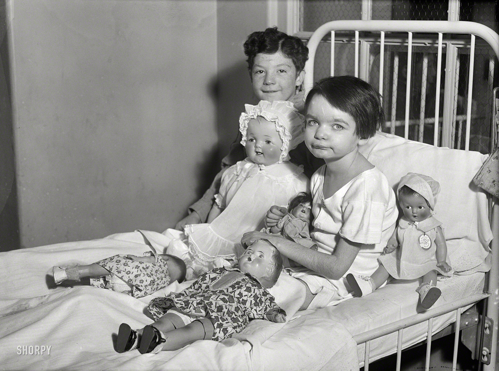 Washington, D.C., 1931. "Children in hospital bed with dolls." Retroactive wishes for a speedy recovery, kids. Harris & Ewing glass negative. View full size.