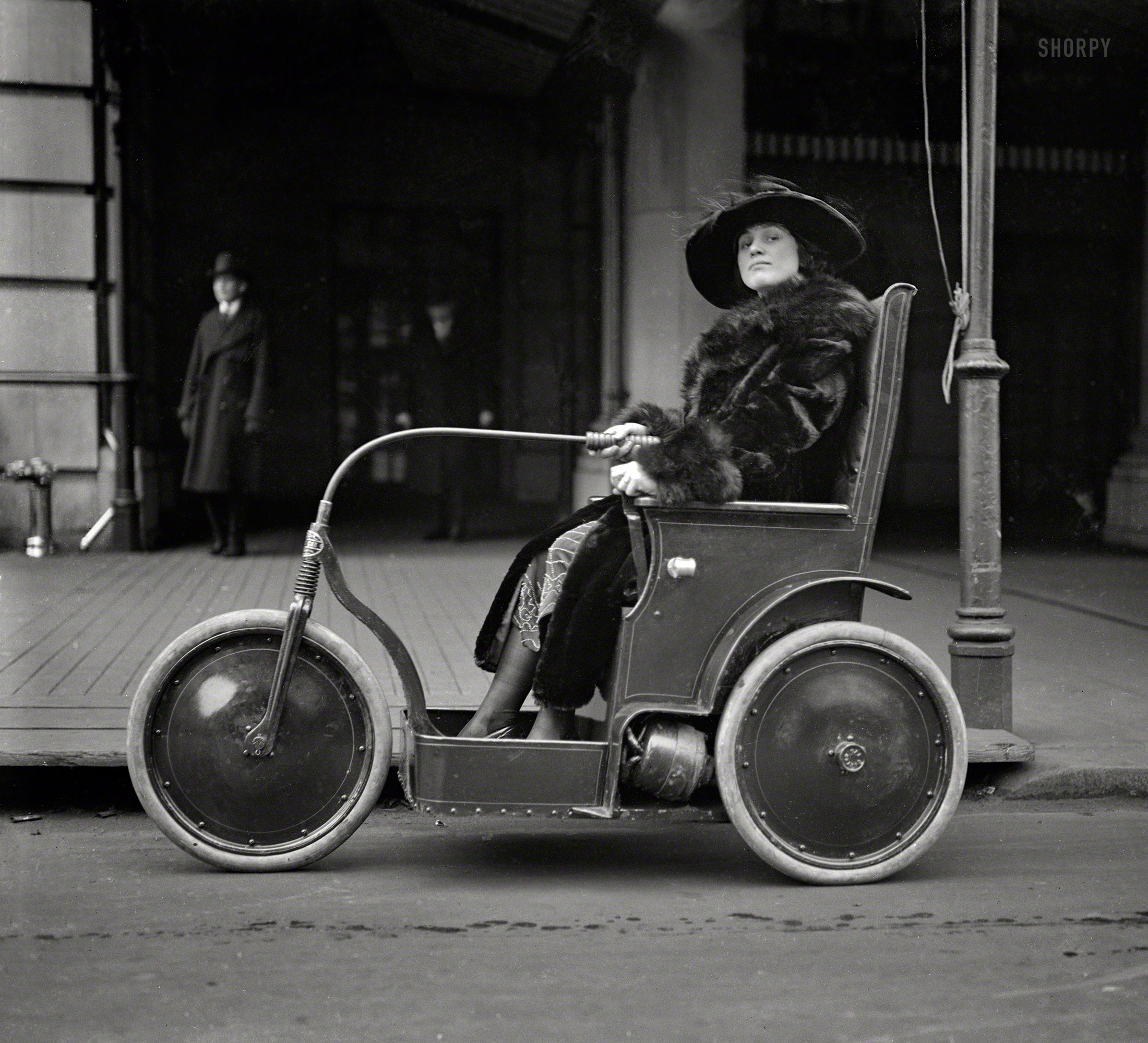 &nbsp; &nbsp; &nbsp; &nbsp; UPDATE: A Washington Post news item identifies this as a Custer "Cootie Car."
Jan. 22, 1922. Washington, D.C. "Woman in three-wheeled vehicle." The electric chair last spied here. Harris & Ewing glass negative. View full size.