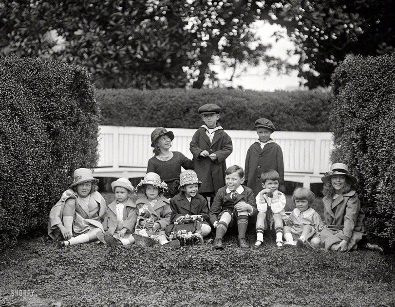 Winsome tots in Easter togs on the White House grounds in 1922. Does it get any cuter than this? We shall see. Now get to work on those eggs. View full size.
