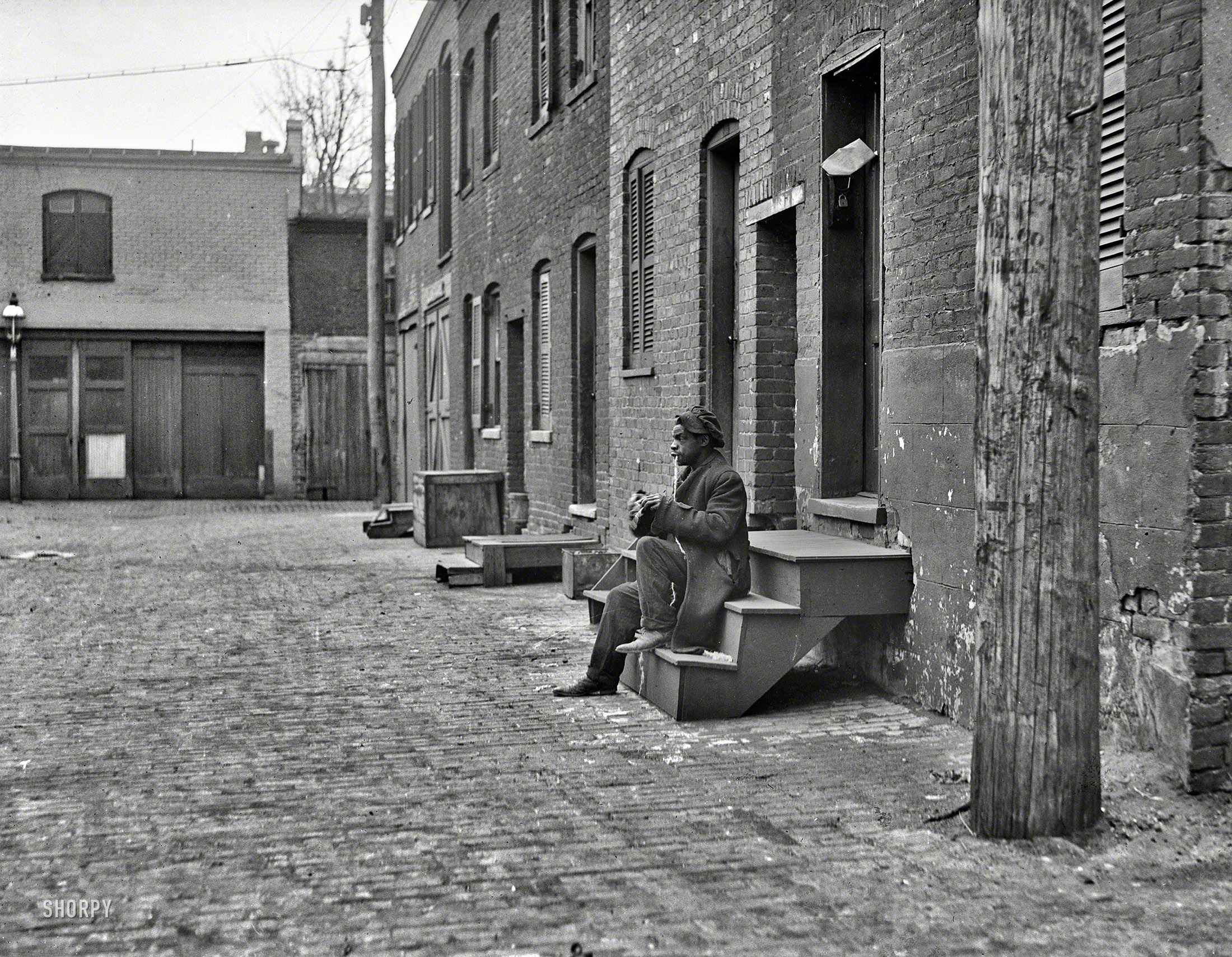Update: This is the west side of Blagden Alley. Details in the comments here. "City rowhouses, 1923." Another view of back-alley Washington, D.C., and its long-forgotten habitues. Harris & Ewing glass negative. View full size.