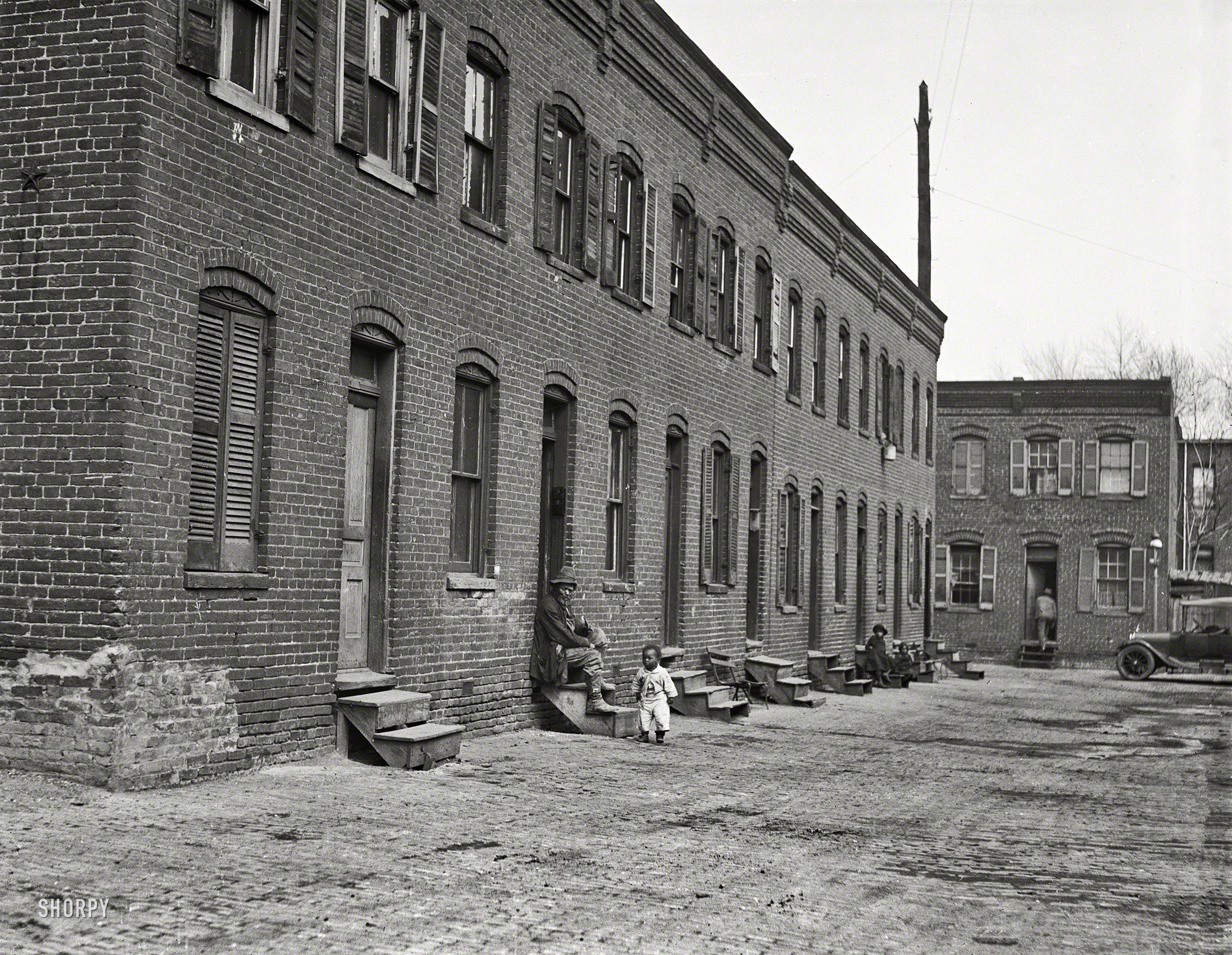 "City rowhouses, 1923." Another glimpse of back-alley Washington, D.C. Added bonus: a nice turnbuckle star. Harris & Ewing glass negative. View full size.