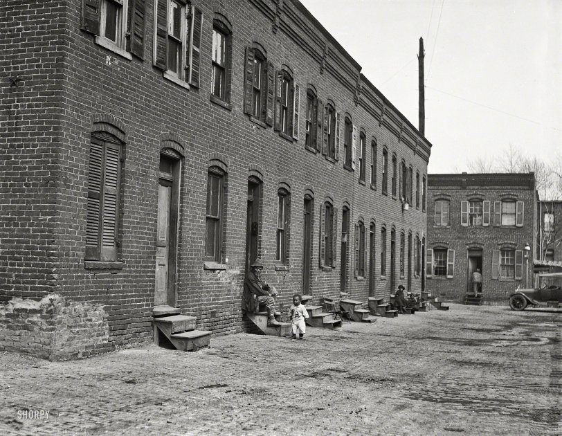 "City rowhouses, 1923." Another glimpse of back-alley Washington, D.C. Added bonus: a nice turnbuckle star. Harris &amp; Ewing glass negative. View full size.
