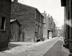 Another 1923 view of back-alley Washington, D.C., from an unlabeled Harris &amp; Ewing plate. Who goes there, aside from the birds? View full size.
Who goes there?Milk Man
Coal Man
Ice Man
Boogey Man
[And horses. Note slitlike apertures to the right. -Dave]
Must beThe alley next to Saint Matthew's Cathedral, looking north toward N Street. 
Fancy LampIt is only an alley, but note the fancy streetlight.  Could that be a gaslight?
[Yes. -Dave]
Could also be- the alley behind St. Margaret's Church on the west side of the 1800 block on Connecticut Ave., NW.  The next time I'm down there, I'll look for any remaining landmarks. 
Krazy Kat Club at the left!This is the same alley as this picture of the Krazy Kat Club. Here's another from a similar angle.
(The Gallery, D.C., Harris + Ewing)