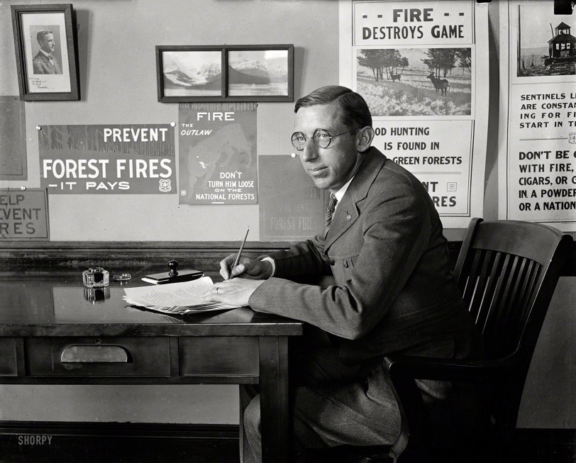 April 1923. Washington, D.C. Another unlabeled Harris &amp; Ewing plate, showing someone we imagine to be the bureaucrat tasked with kindling fire-prevention slogans. Say, does it seem a little smokey in here? View full size.
