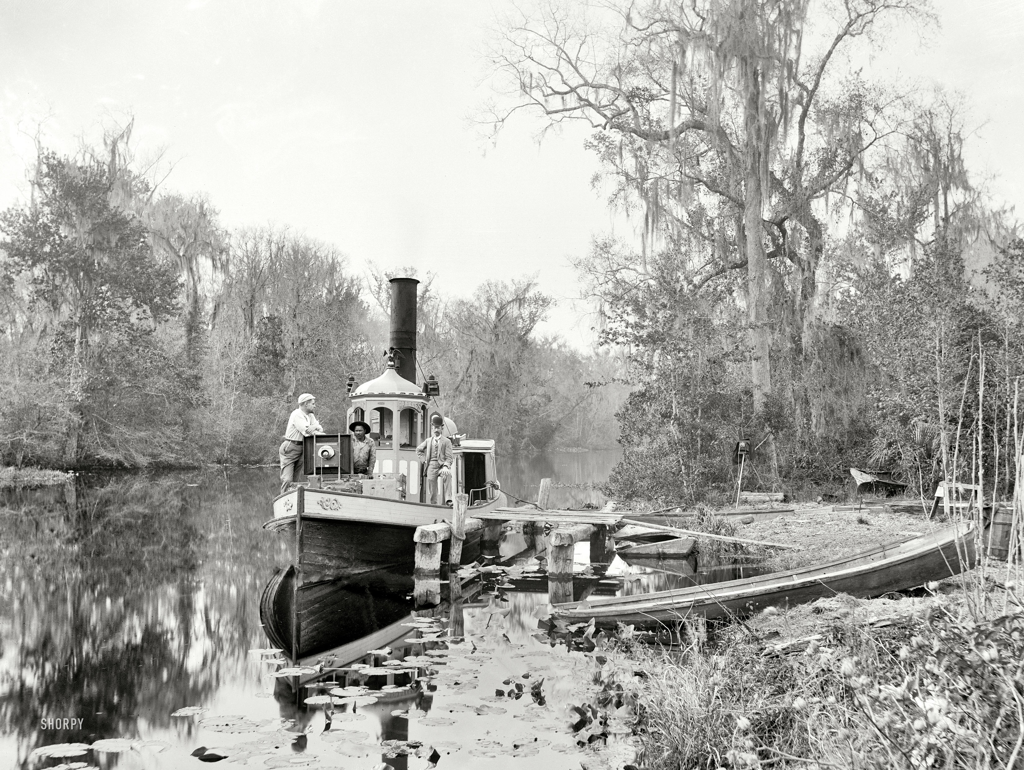 Florida in the 1890s. "Brown's Landing, Rice Creek." Note the enormous 18x22 inch "mammoth plate" view camera set up on the bow of the Princess. 8x10 inch glass negative by William Henry Jackson, whose photographs formed the basis of Detroit Publishing's holdings in the company's early days. View full size.